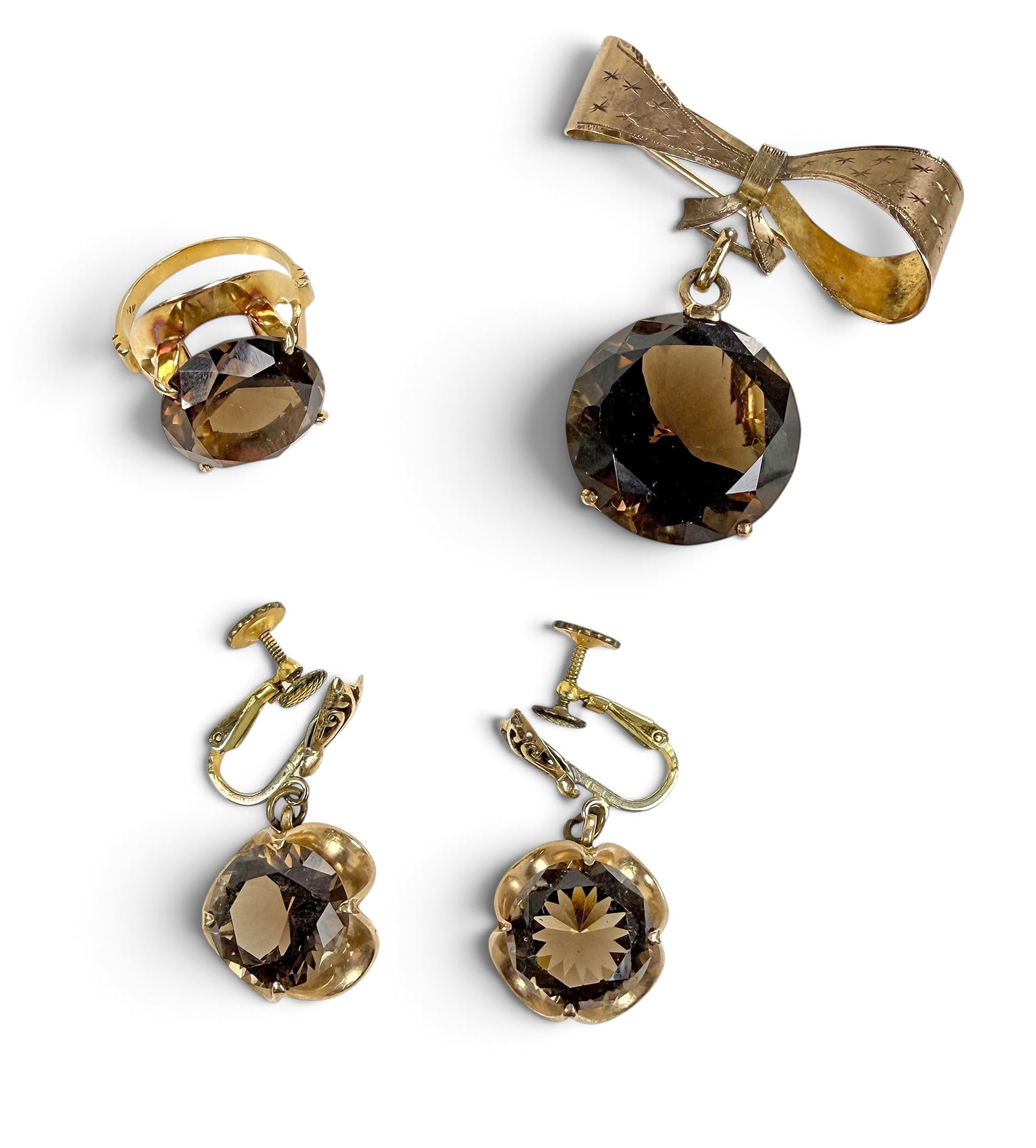 Vintage 14K Smoky Quartz 3-Piece Demi-Parure.: The lot contains a brooch, a ring, and a pair of earrings. The pieces feature large round smoky quartz stones set in 14K yellow gold. The earring stones measure 12mm in diameter, the ring stone measur