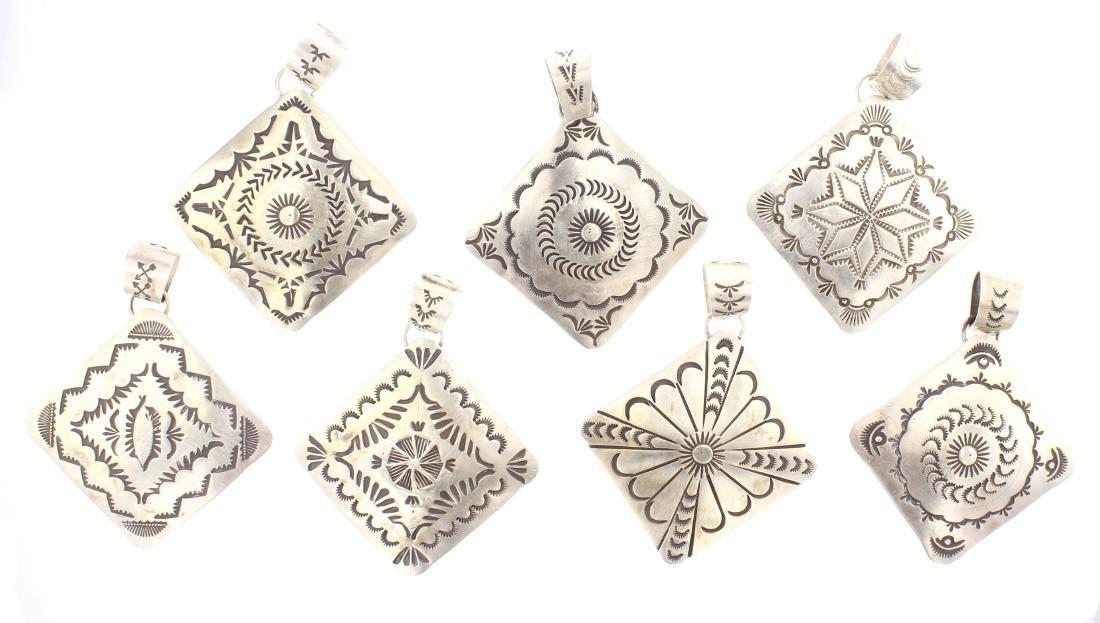 Rick Enriquez Silver Stamp Pendant Lot of Seven: Sterling Silver | | Rick Enriquez Silver Stamp Pendant Lot of Seven | Navajo Native American Southwest Indian Jewelry | Dimensions: (7) Pendents: 2" x 2.75" (for all) | Weight: 97.7 Grams, | Signed: R