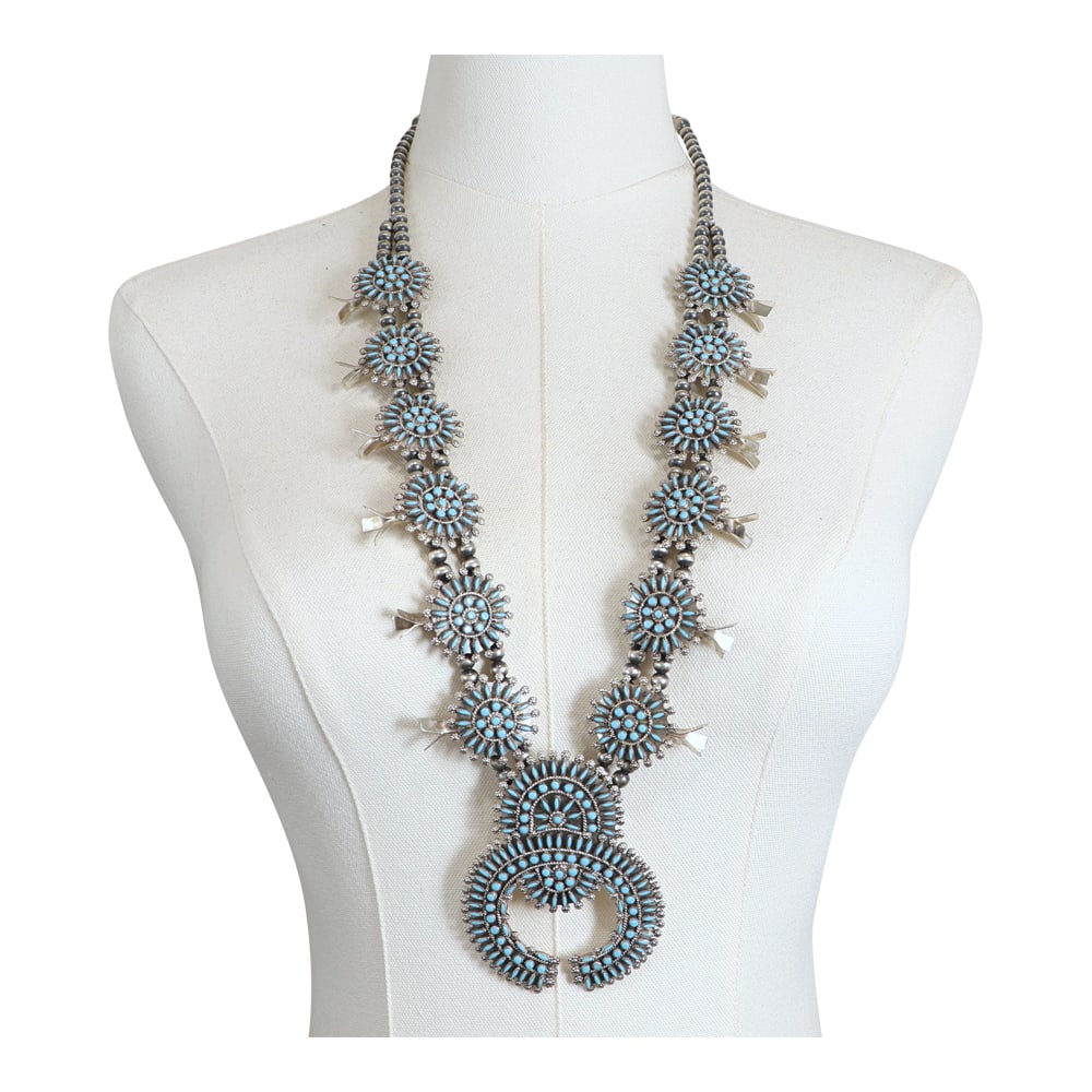 Delbert & Melinda Chavez Zuni Sleeping Beauty Turquoise Needlepoint Petit Point Squash Blossom: Sterling Silver | Genuine Sleeping Beauty Turquoise | Delbert & Melinda Chavez Zuni Sleeping Beauty Turquoise Needlepoint Petit Point Squash Blossom Necklace | Zuni Native American Southwest Indian Je