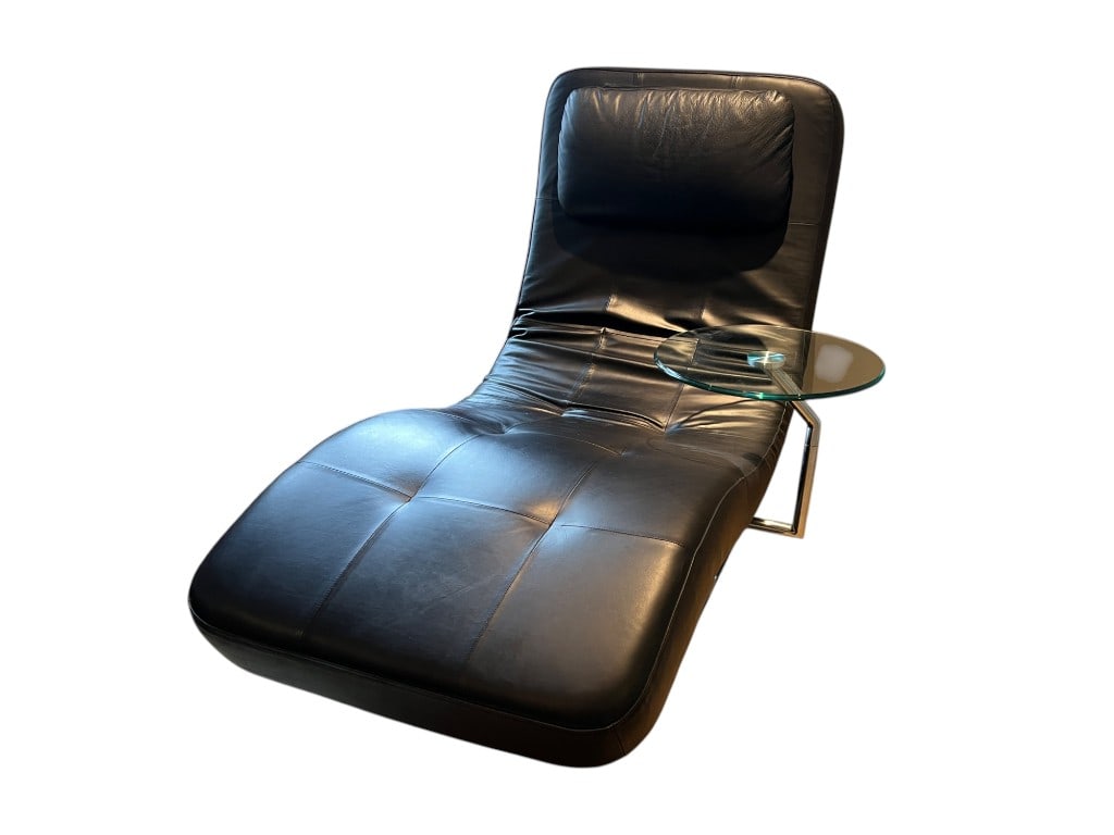 $2,000 A modern chaise lounge upholstered in black leather featuring a low-profile, contoured silhou (1 of 7)