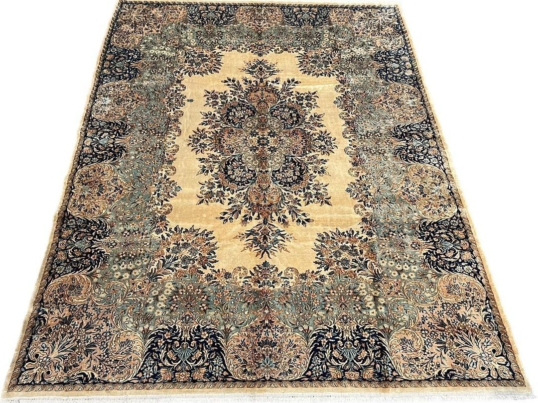 $27,200 This substantial area rug features the renowned Persian Kerman, crafted from high-quality wo: $27,200 This substantial area rug features the renowned Persian Kerman, crafted from high-quality wool using a hand-knotted weave that ensures both durability and refined detail. The design incorporat