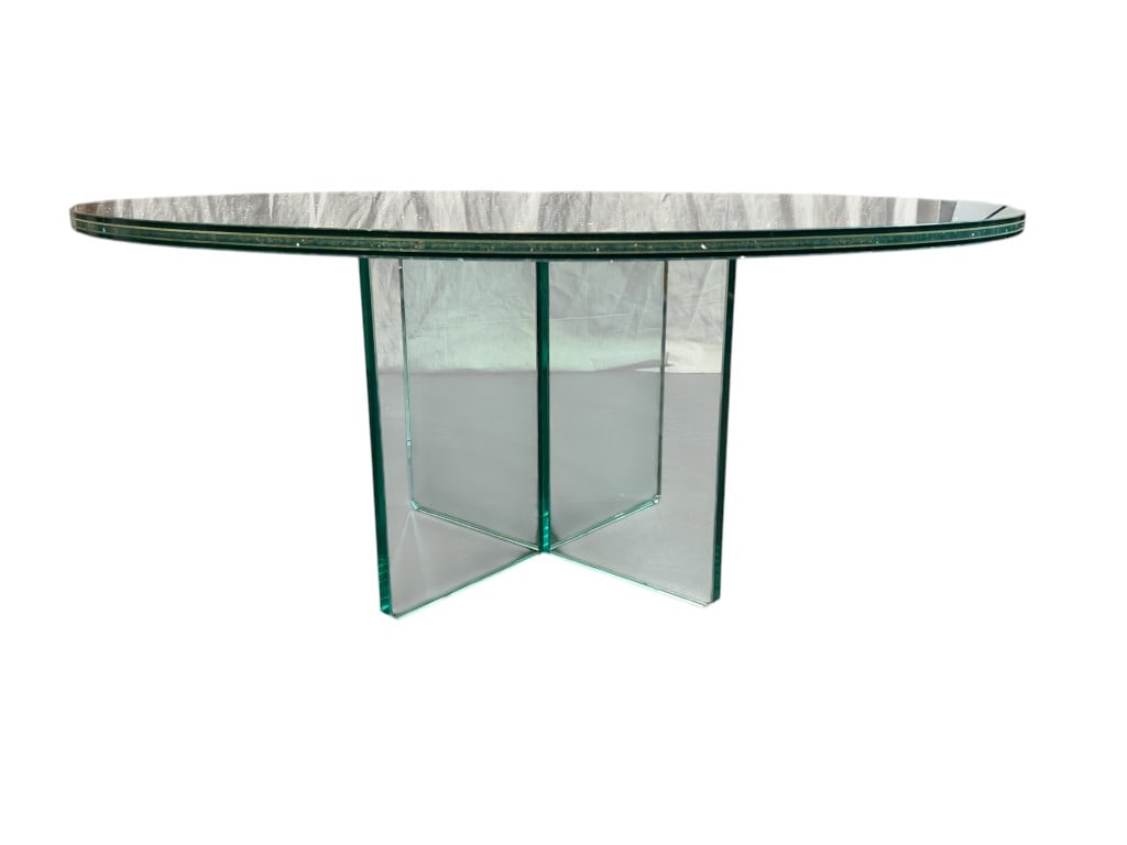 This coffee table features a round shaped top made from crackle-effect glass, characterized by intri: This coffee table features a round shaped top made from crackle-effect glass, characterized by intricate, web-like fracture patterns throughout the surface that create a unique texture and visual dept