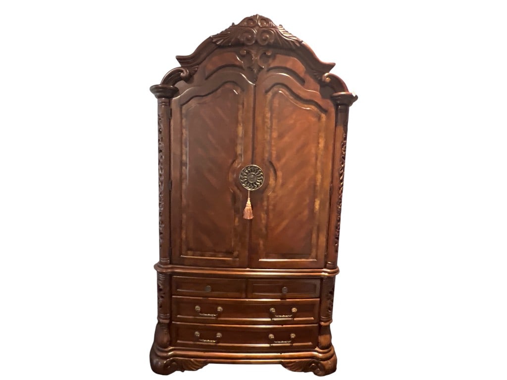 $5,000+ Michael Amini AICO Signature Series Carved Wood Armoire, 92"H: Armoire from the Michael Amini Signature Series by AICO. Constructed from richly grained wood with a warm finish, the piece features ornate hand-carved detailing on the crown and sides, and decorative