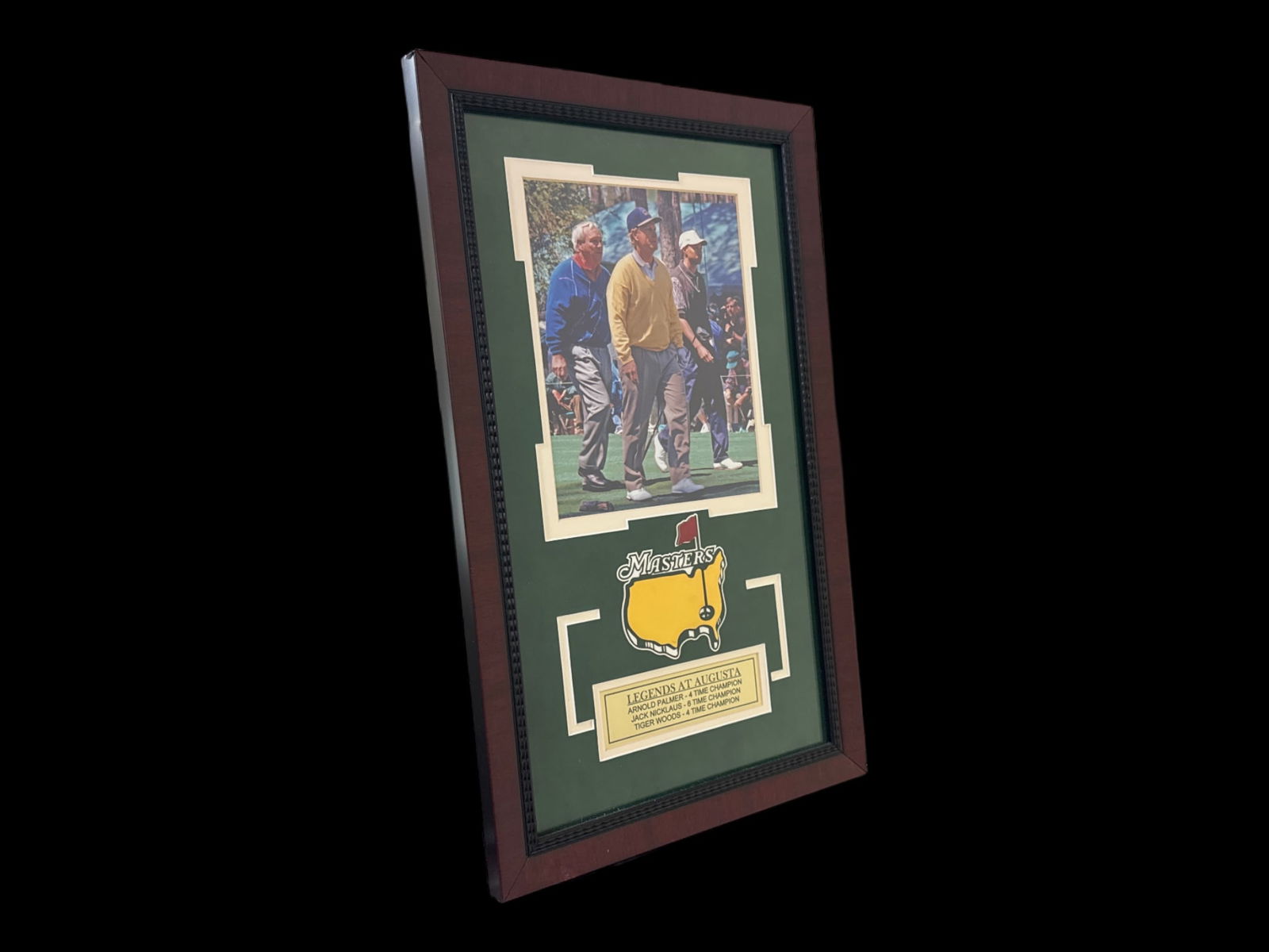 Masters Tournament Legends at Augusta Framed Golf Memorabilia: This framed collectible titled "Legends at Augusta" prominently features a photographic print of three iconic golfers walking on the green, seated above the official Masters Tournament logo set agains