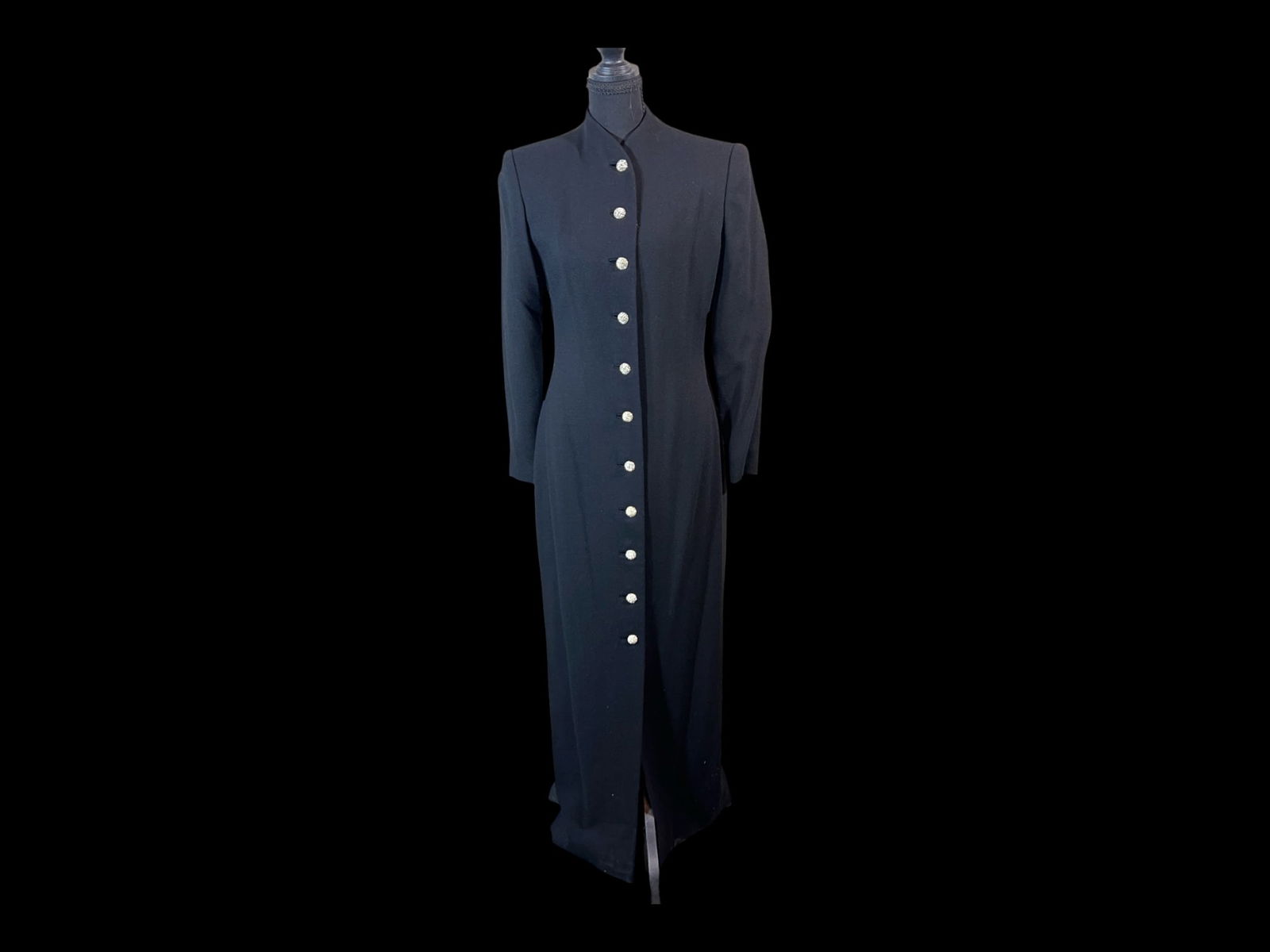 Saks Fifth Avenue Made-in-U.S.A. Black Evening Overcoat with Rhinestone Buttons, Size 8: An elegant late-20th-century black tailored evening overcoat labeled Saks Fifth Avenue, made in the U.S.A., cut in a long, architectural silhouette with restrained formal detailing. The coat presents