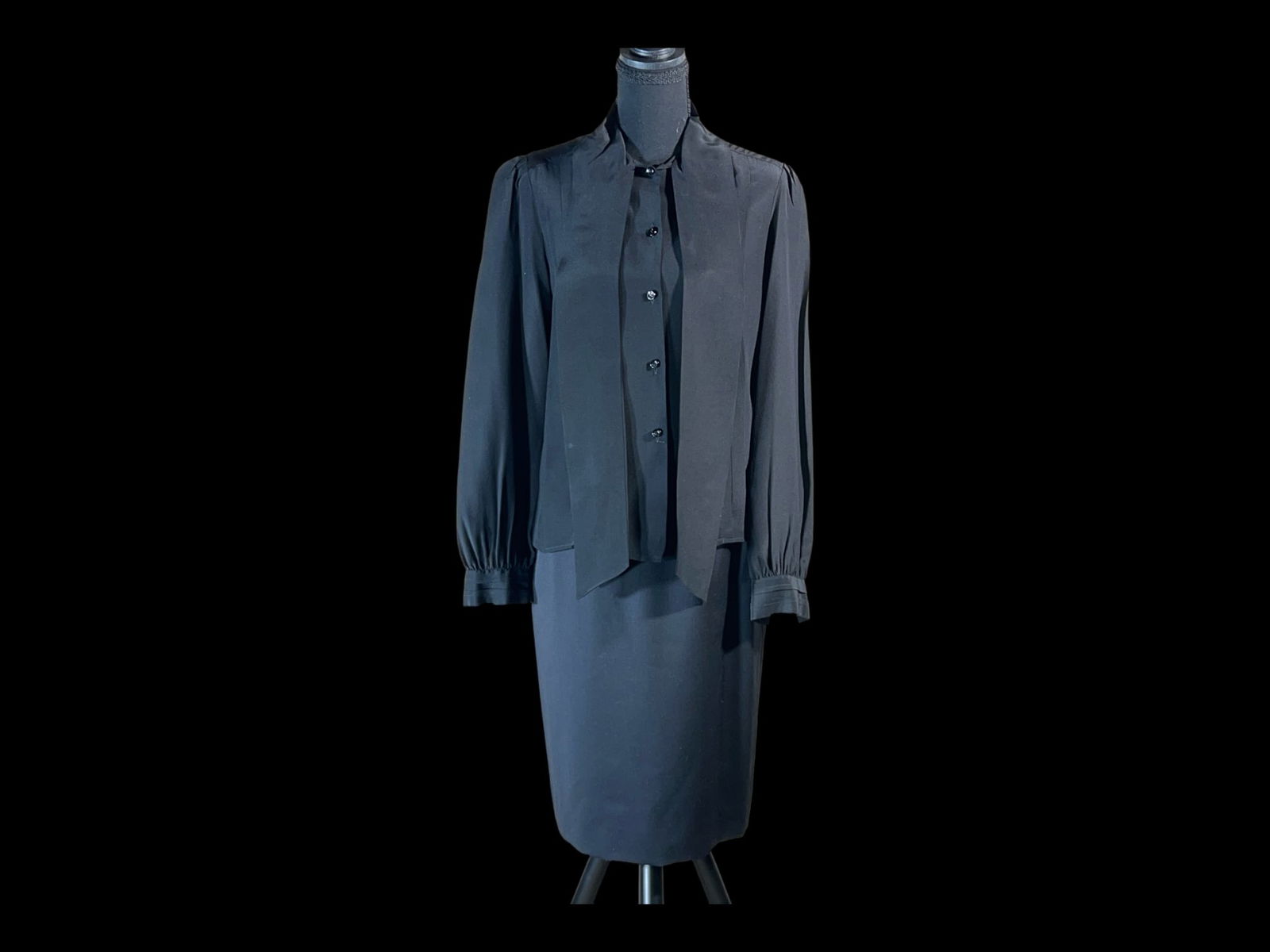 Adolfo at Saks Fifth Avenue Black Bow-Neck Blouse and Pencil Skirt Ensemble: A refined late-20th-century Adolfo at Saks Fifth Avenue two-piece ensemble comprising a black blouse with integrated scarf-tie neckline and a coordinating pencil skirt, likely American retail producti