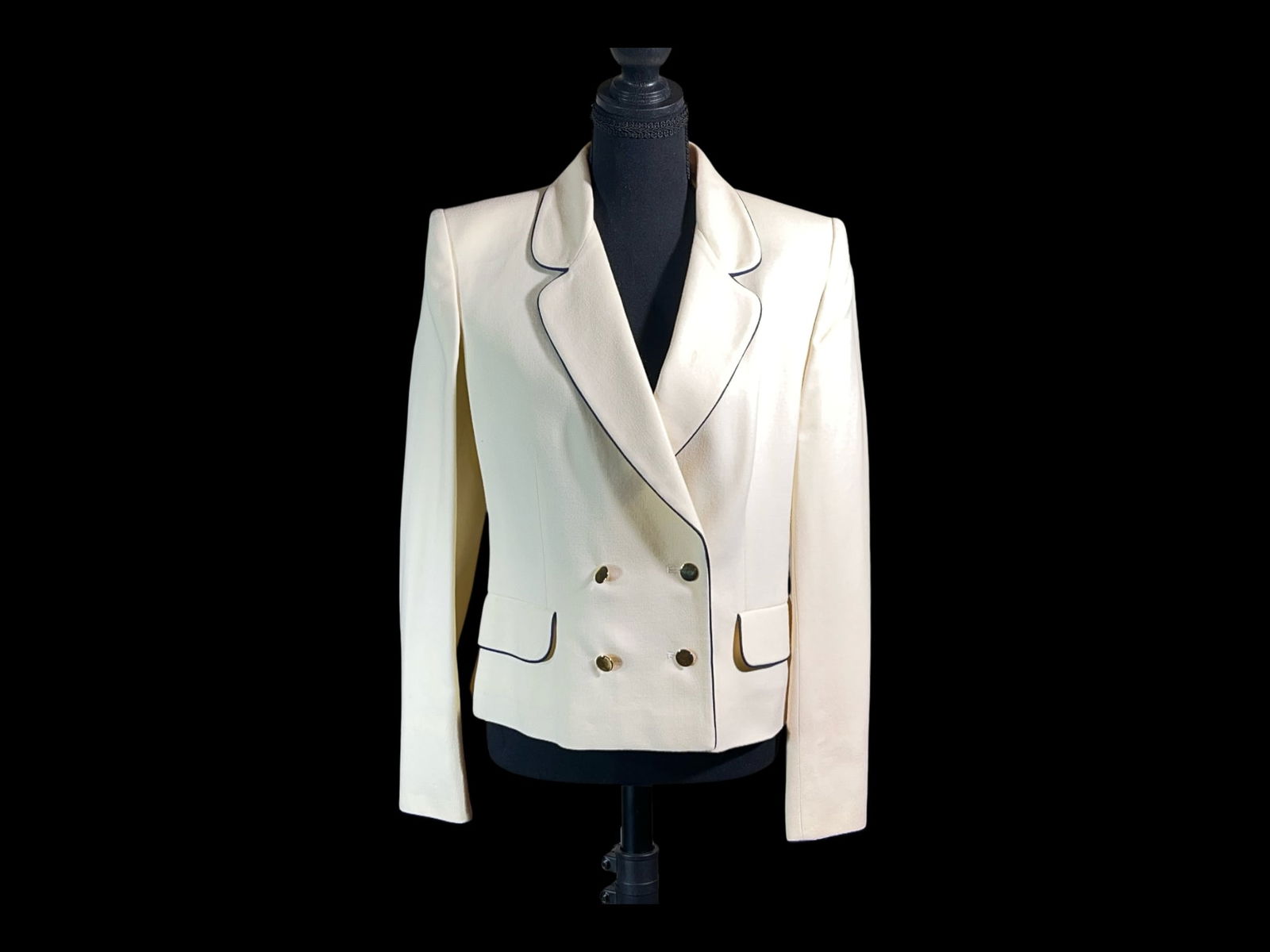 Jaeger Cream Wool Double-Breasted Blazer with Contrast Piping, Made in Great Britain (Size 12): A tailored late-20th-century style cream wool blazer by Jaeger, made in Great Britain, executed in a crisp, structured cloth with sharp contrast piping for a graphic, equestrian-inflected finish. Cut