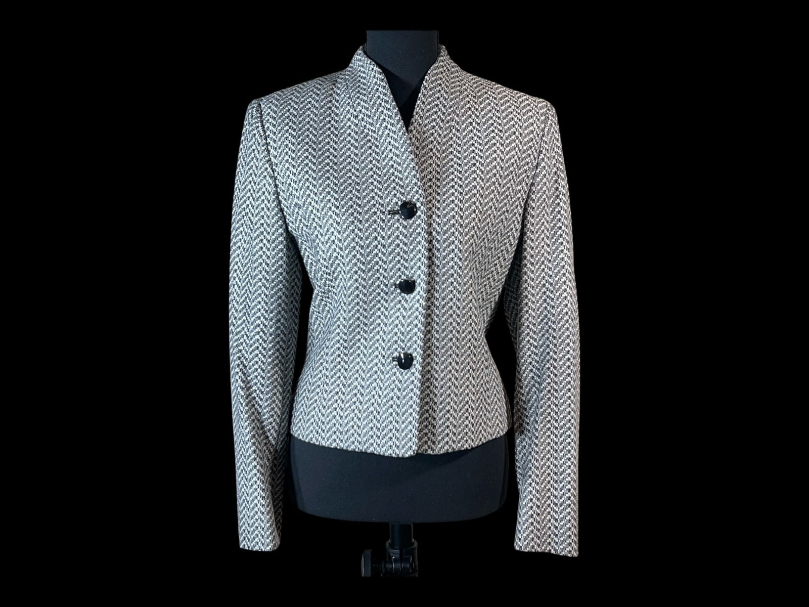 Jaeger (British) Black-and-White Herringbone Wool-Cashmere Jacket, Made in Great Britain: A tailored Jaeger British-made jacket in a black-and-white herringbone wool blend, presenting a crisp, collarless silhouette with a clean, architectural line. The jacket is cut to a shaped, waist-defi