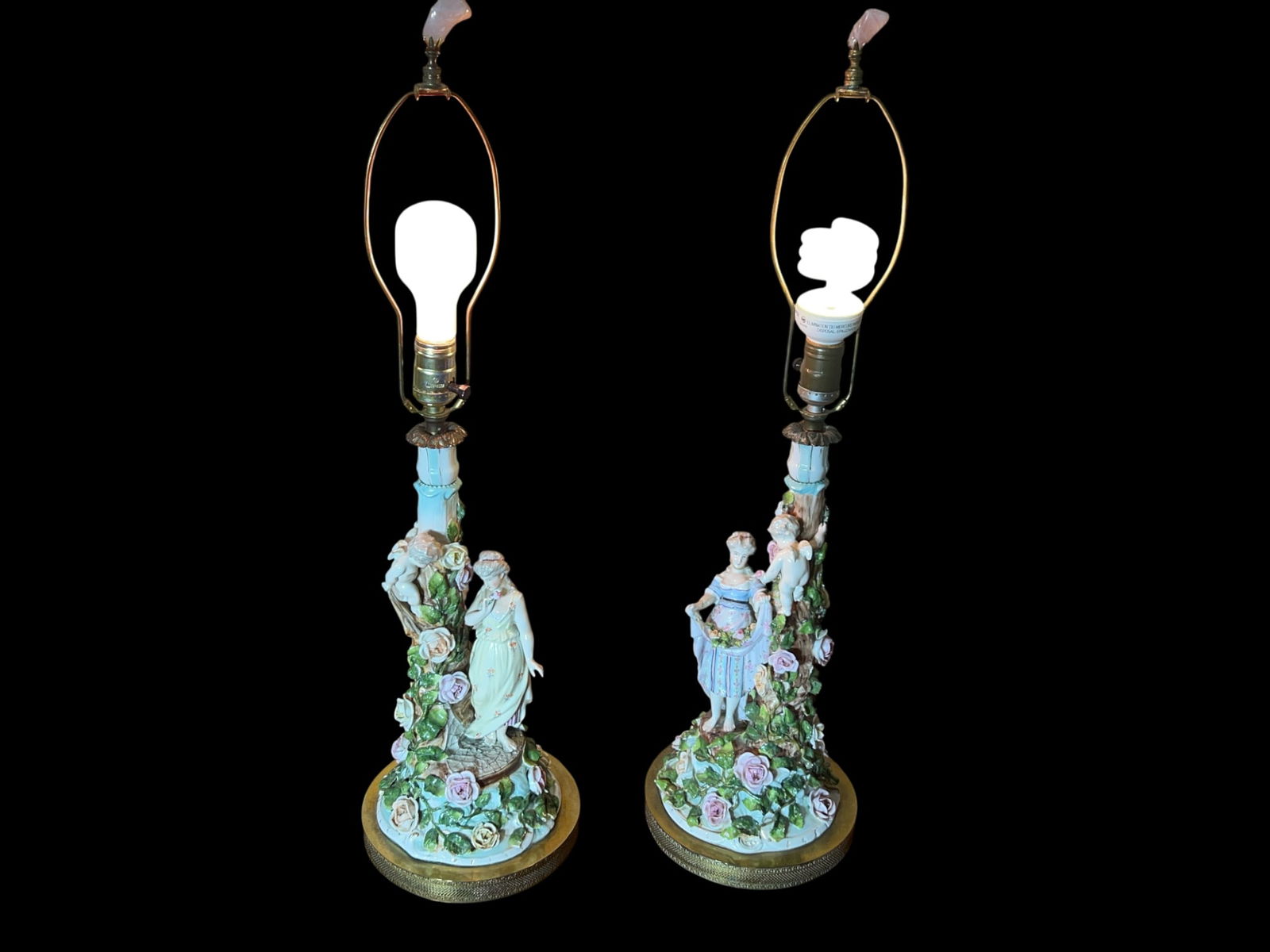 Pair of Rococo Revival Porcelain Figural Table Lamps with Applied Roses and Cherubs, 28" H: A romantic Rococo Revivalâ€”style pair of polychrome glazed porcelain figural table lamps, likely Continental/Italian in the Capodimonte taste. Each lamp is modeled as a vine-wreathed column risi