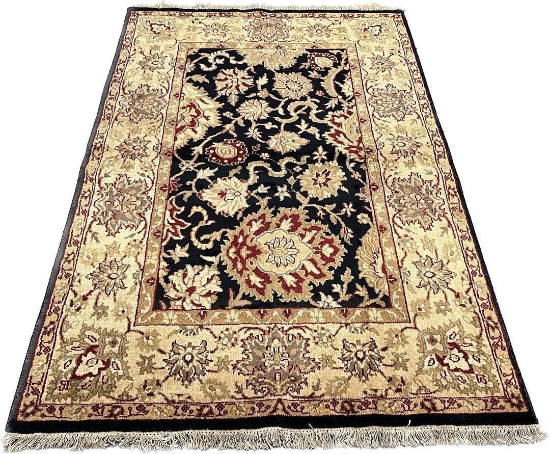 Traditional Jaipur Wool Area Rug 4'11" x 7'5": Elegant handmade wool area rug featuring a sophisticated black field adorned with intricate floral and vine motifs in cream and burgundy tones. The stunning design showcases a harmonious blend of deli