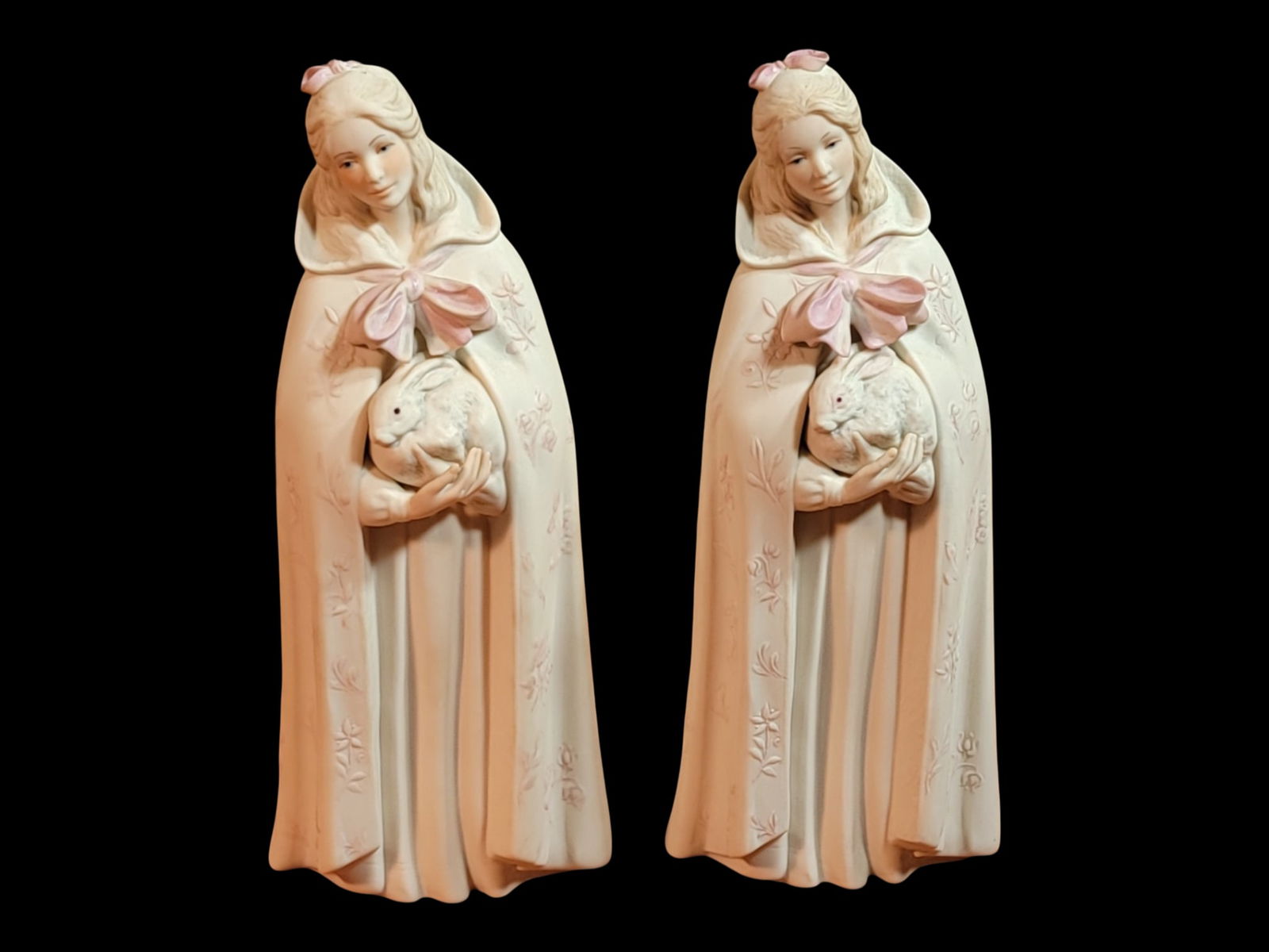 Pair of Gillis White Bisque Porcelain Figures of a Cloaked Girl Holding a Rabbit, with Quipco Chase : A charming pair of late 20th-century-style white bisque porcelain figural sculptures depicting a young girl cradling a rabbit, executed in a softly romantic, cottage-garden idiom. Each figure is model
