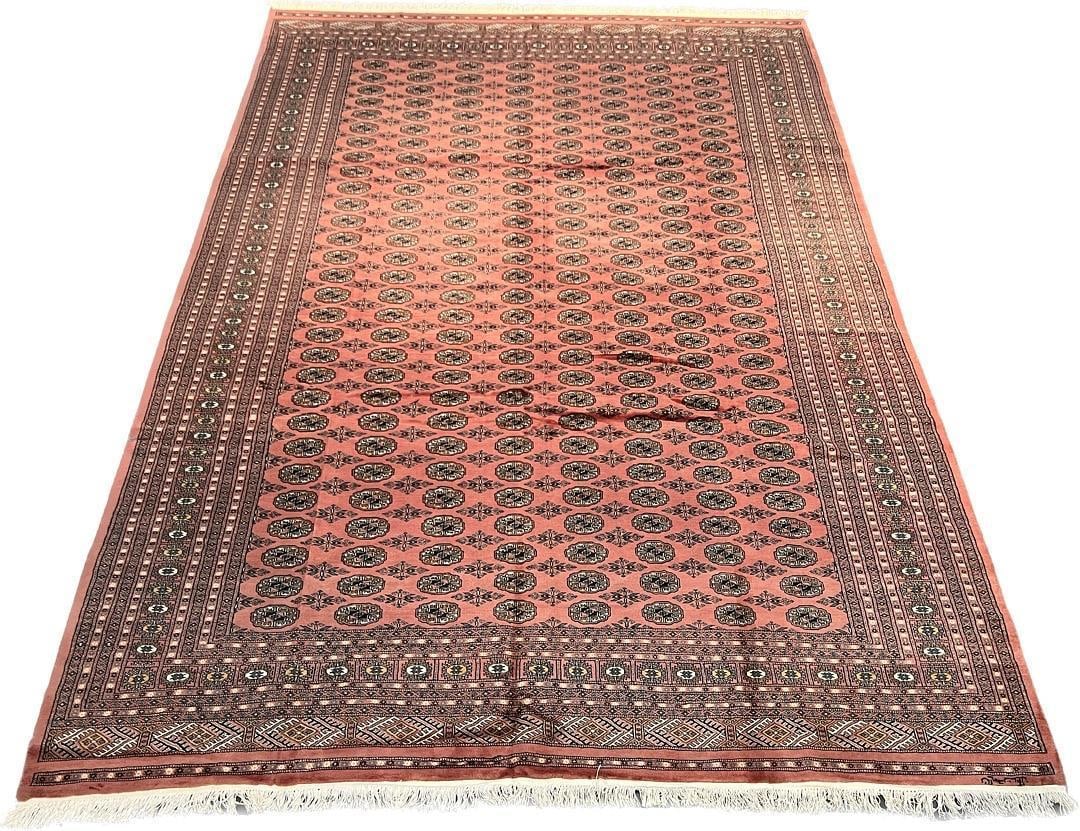 Traditional Bokhara Wool Area Rug 9'1" x 12'9": Genuine handmade Bokhara wool rug featuring a classic repeating gul pattern on a salmon-pink field. The intricate geometric medallions are arranged in a traditional tekke format, complemented by multi