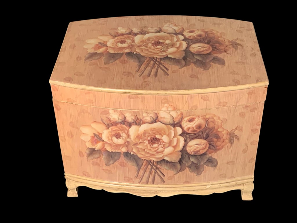 Decorative Wooden Floral Painted Storage Chest: This wooden storage chest features a curved rectangular shape with hand-painted floral designs on the top and front panels. The artwork depicts a bouquet of soft-colored flowers including roses accent