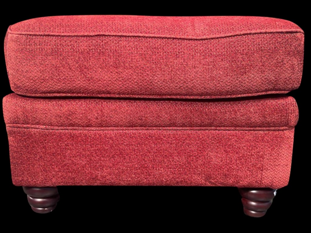 Upholstered Red Fabric Ottoman with Wood Bun Feet: This rectangular ottoman features a deep red fabric upholstery with subtle texture and solid stitching along the edges. The cushion is plush and slightly rounded at the corners, resting on a sturdy ba