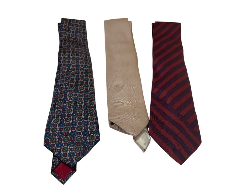 Set of Three Designer Silk Neck Ties: Geoffrey Beene, Nina Ricci, and Imported Striped Pattern: Set features three distinctive menâ€™s neck ties, each offering unique style and craftsmanship. The first tie, by renowned designer Nina Ricci, is hand-made in France and crafted from