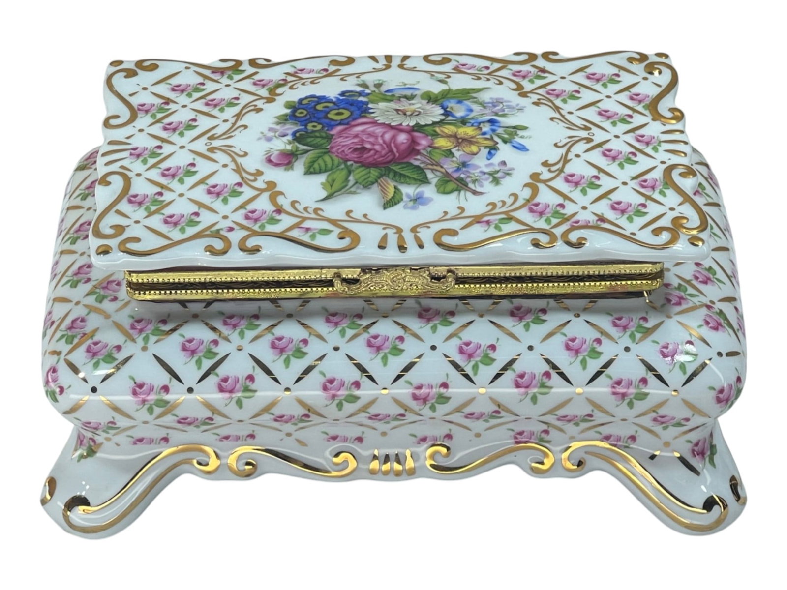 Porcelain Trinket Box with Hand-Painted Floral Bouquet and Gilt Bronze Mount: This elegant porcelain casket showcases exceptional European decorative artistry. The lid displays a central hand-painted bouquet featuring pink roses, blue primroses, white daisies, and yellow blooms