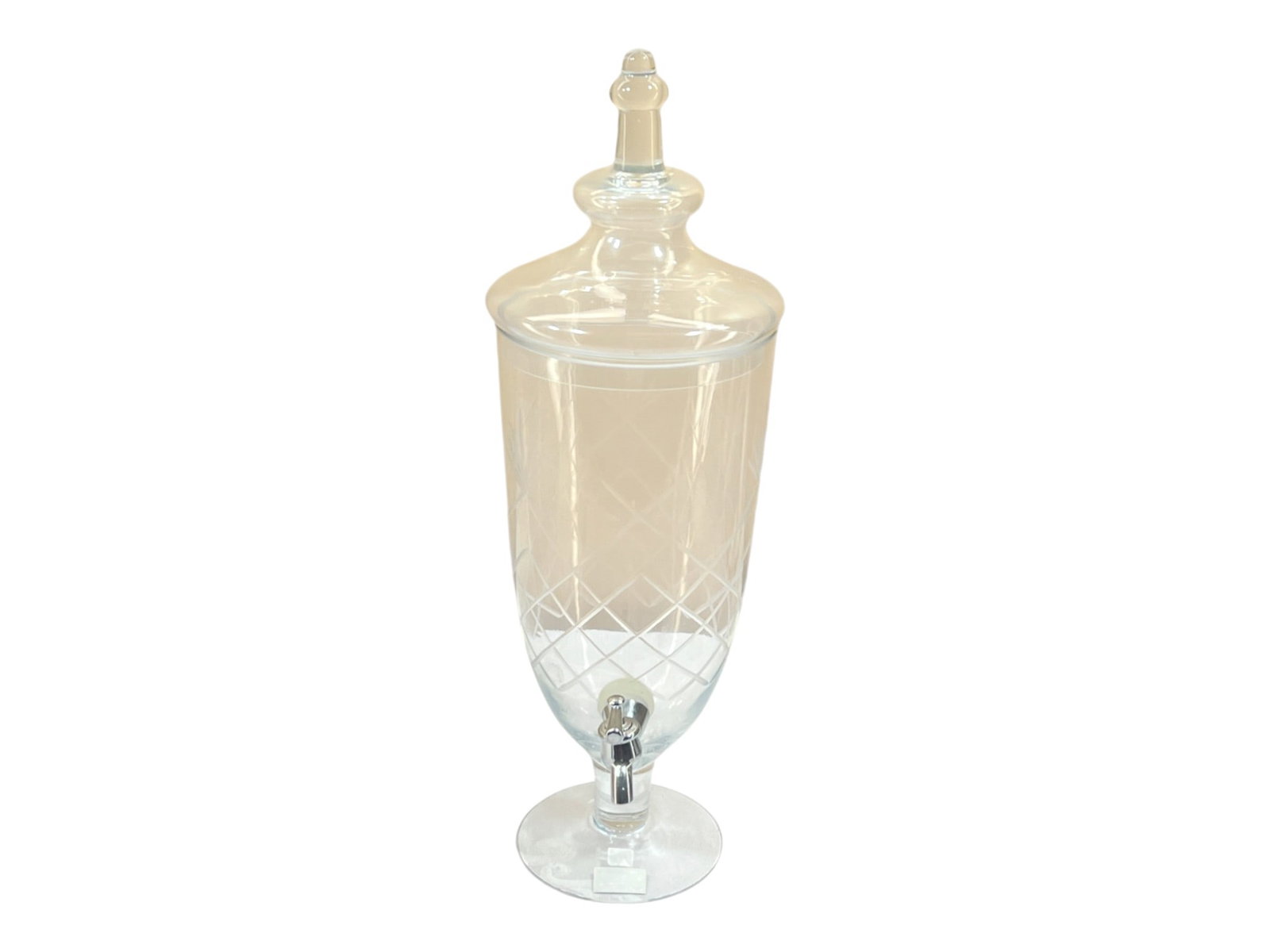 Clear Cut Glass Beverage Dispenser with Diamond-Cut Etching and Chrome Spigot, 20": Elegant footed glass beverage dispenser featuring intricate diamond-cut crosshatch etching on the body and wheat or leaf motif engraving visible in interior detail. The piece is constructed from clear