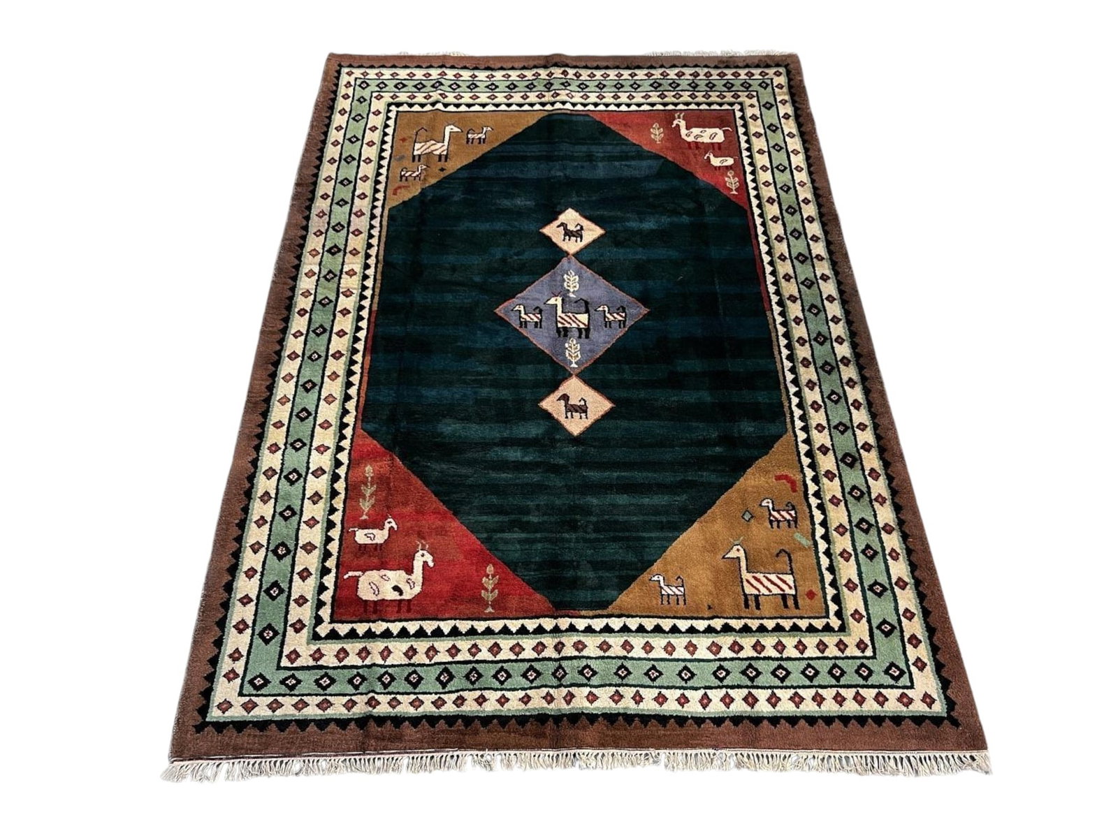 $4,185 - Folk-Art Animal Carpet, Gabbeh Design, Hand-Knotted Wool, 8'3" x 11'4": $4,185. A large teal-green diamond fills the centre, set against red, ochre and brown corner blocks and populated with naive animal and figural motifs in lilac, cream and red, with concentric borders