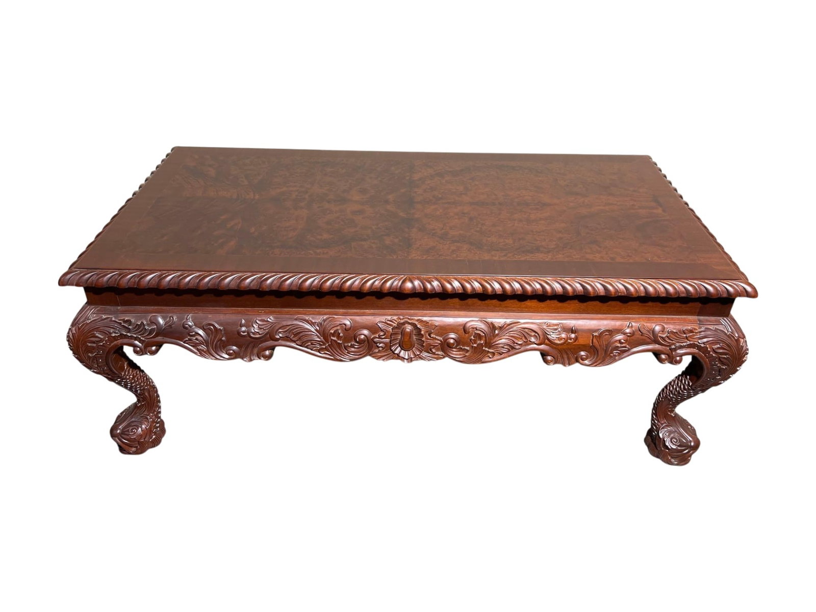 $3,500 High-End Carved Burl Mahogany Coffee Table with Scroll and Shell Motifs: This coffee table is crafted from rich burlmahogany wood featuring intricate hand-carved details including a scalloped edge and ornate scroll and shell motifs along the apron. The legs are stylized