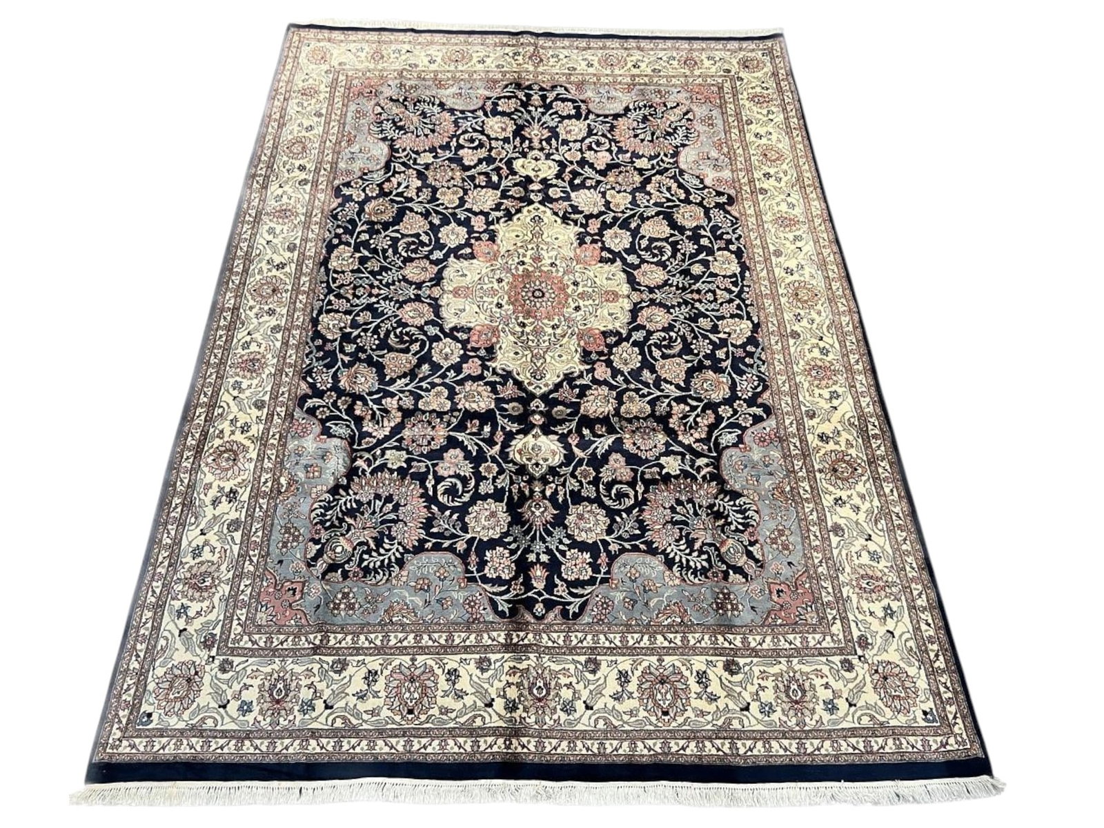 $8,220 - Navy and Ivory Medallion Carpet, Kashan Design, Hand-Knotted Wool, 9'0" x 12'5": $8,220. A deep navy field is centred by an ivory and salmon lobed medallion with pendant finials, surrounded by scrolling floral vinery and answered by matching corner spandrels beneath a generous ivo