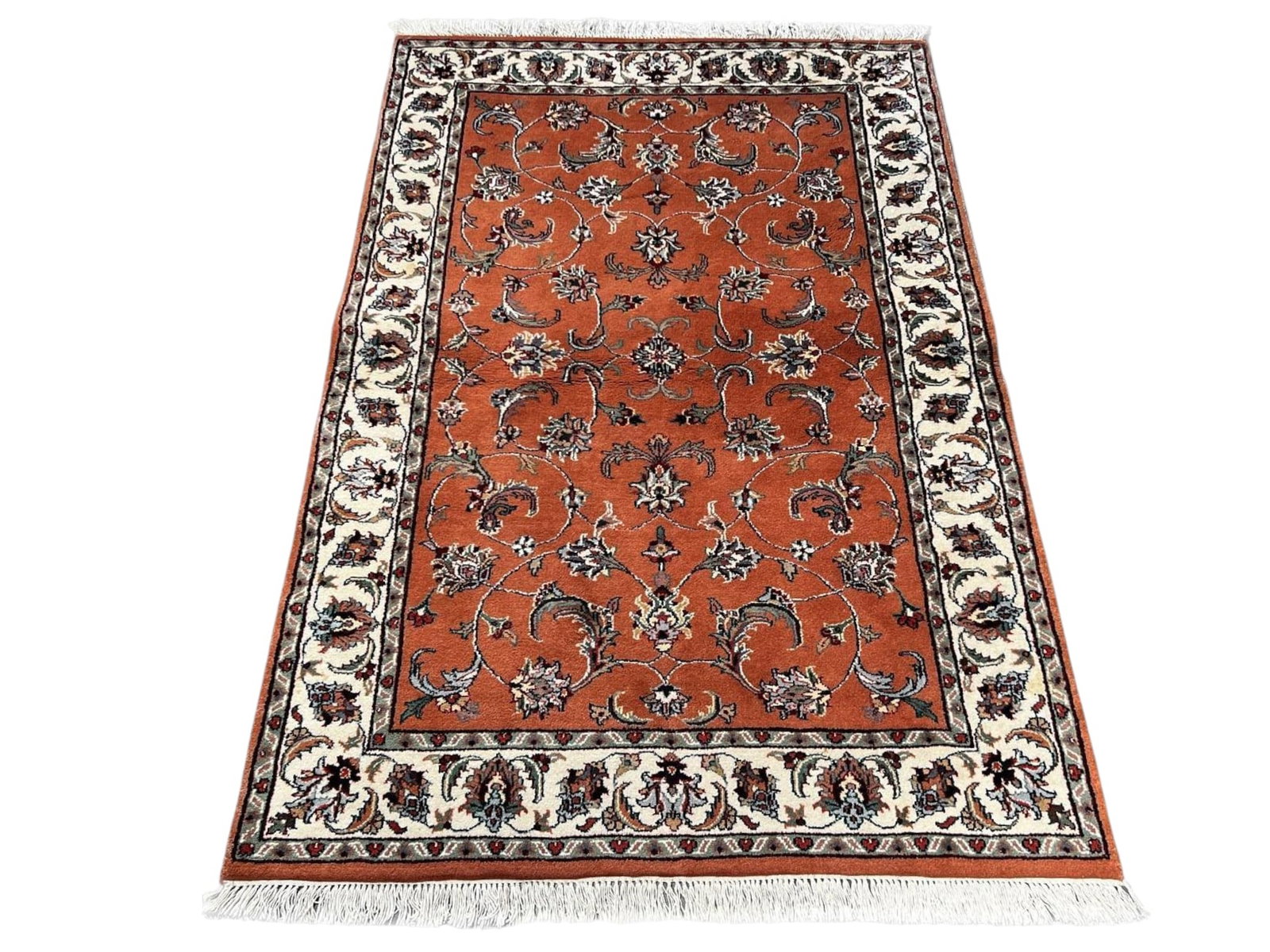 $1,580 - Rust Ground Floral Rug, Kashan Design, Hand-Knotted Wool, 3'11" x 5'9": $1,580. A warm rust-terracotta field is filled with a fine allover of blossoms, curling leaves and vine in grey, ivory and black, framed by a bright ivory border of linked palmettes. Compact formats