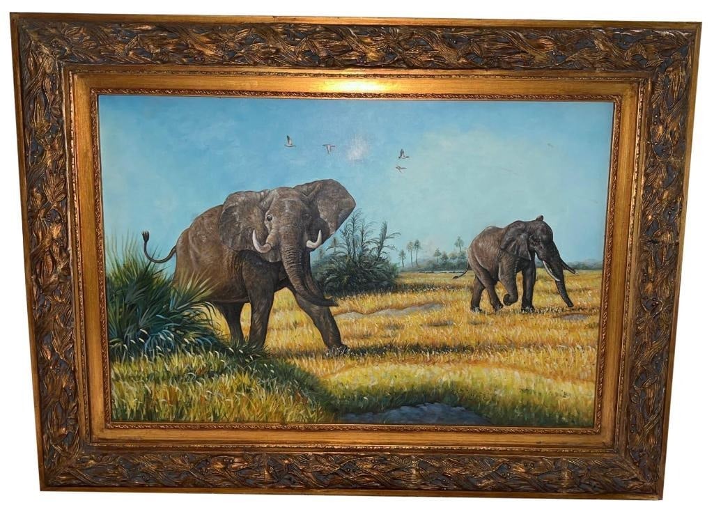 Elephant Wildlife Scene Oil Painting with Gilded Carved Frame: This oil painting depicts two elephants in a grassy field beneath a bright blue sky with flying birds. The artwork showcases detailed brushwork with textured paint capturing foliage, animal features,