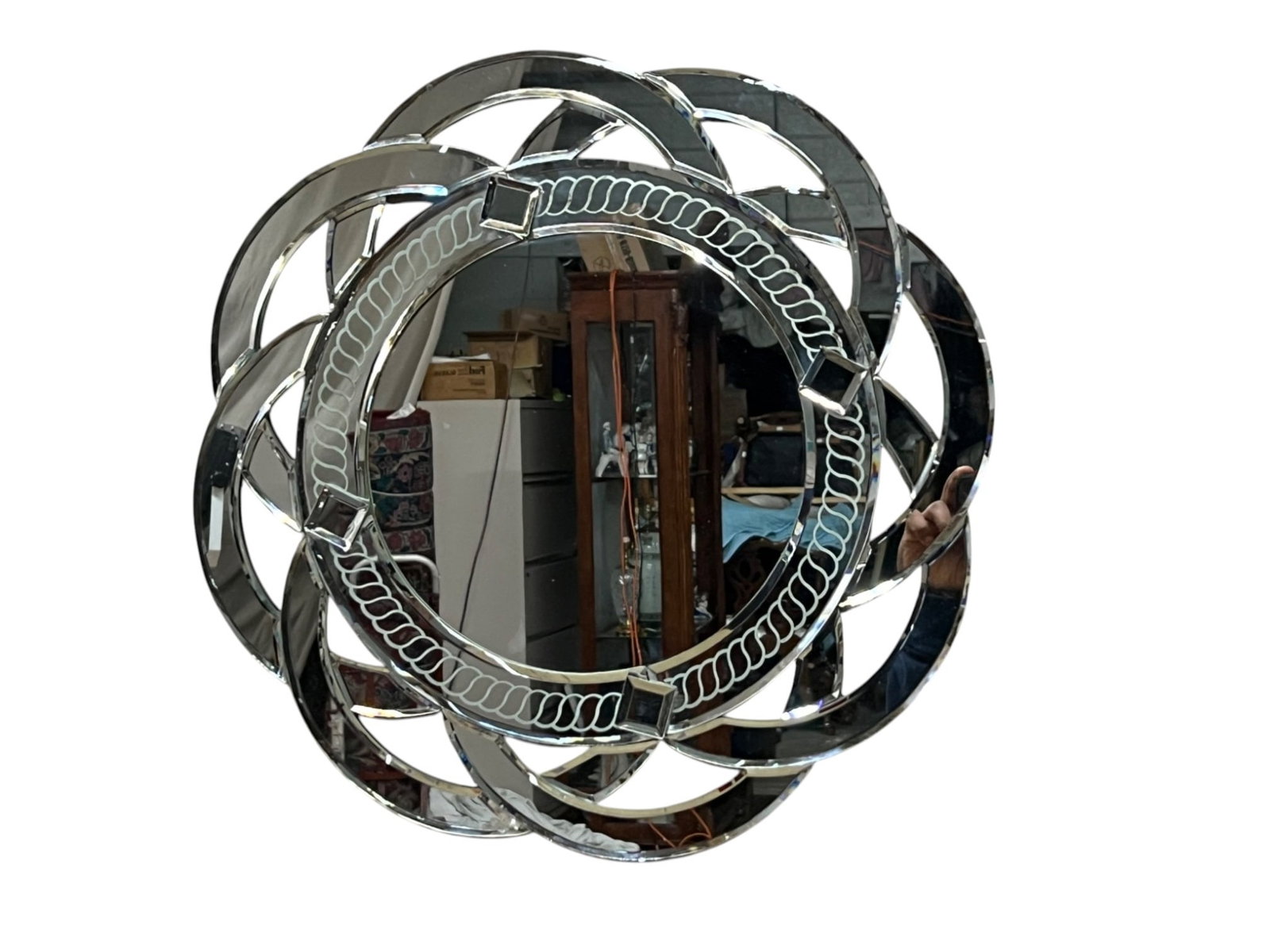 Mirror wall décor with beveled circular frame, 20 x 20: Decorative wall mirror with a bold circular silhouette composed of overlapping beveled mirrored bands surrounding a central round looking glass. The inner border features an etched repeating loop moti