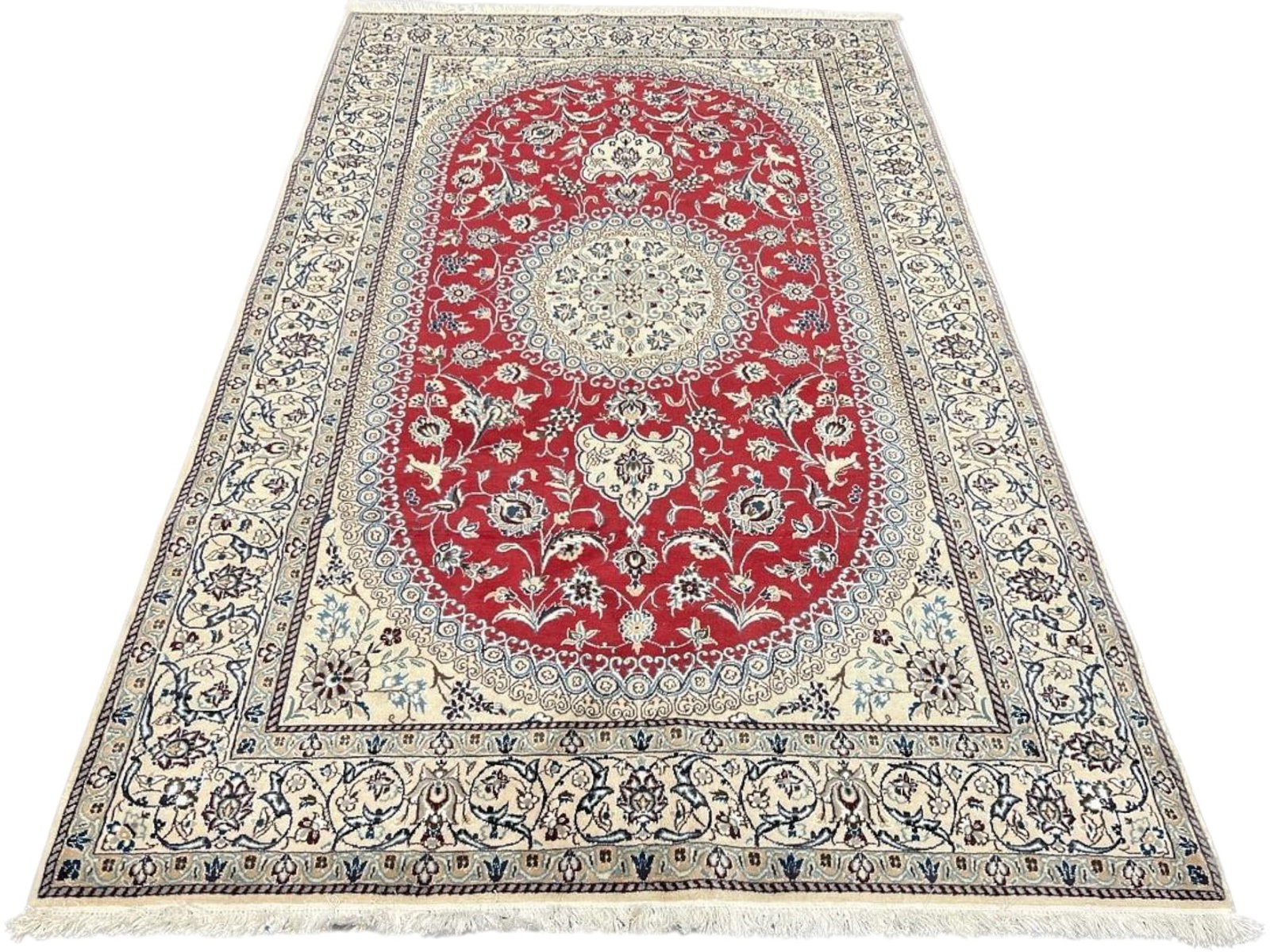 $7,755 - Salmon Field Persian Nain Rug, Hand-Knotted Wool & Silk, 5'0" x 8'1": $7,755. A warm salmon-red field is set against a large ivory oval medallion, surrounded by fine floral tracery, with a cream border carrying blue-accented arabesques. The colouring is unusual for a Na