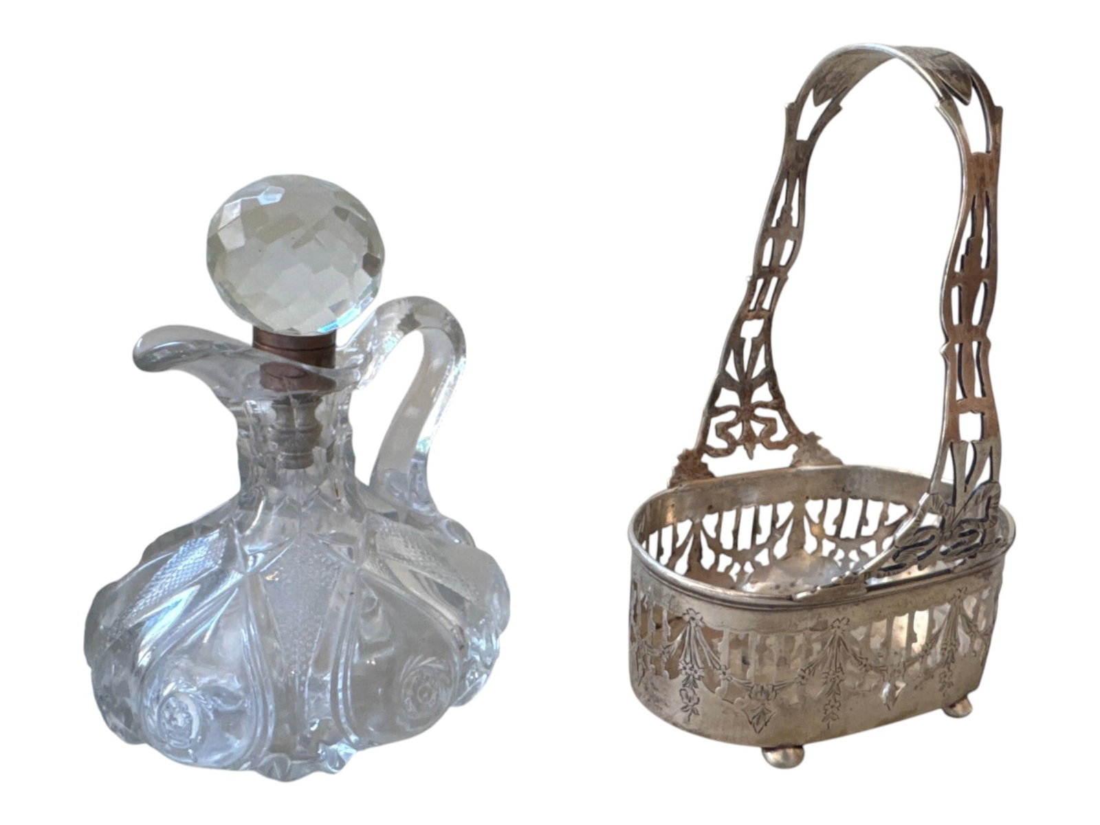 Silverplate Pierced Basket with Swing Handle, 8 in.: Decorative silverplate basket with an oval body, pierced gallery sides, and an openwork swing handle featuring stylized geometric and foliate motifs. The body stands on four small ball feet, and the