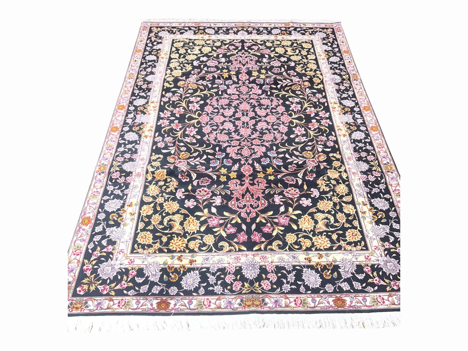 Fine Persian Tabriz Wool and Silk Rug, Black Ground Floral, 6'5" x 9'5": A very finely woven Persian Tabriz carpet in wool with silk highlights, hand-knotted and of collector quality. The field is laid over a deep black ground, an uncommon and dramatic choice that throws t