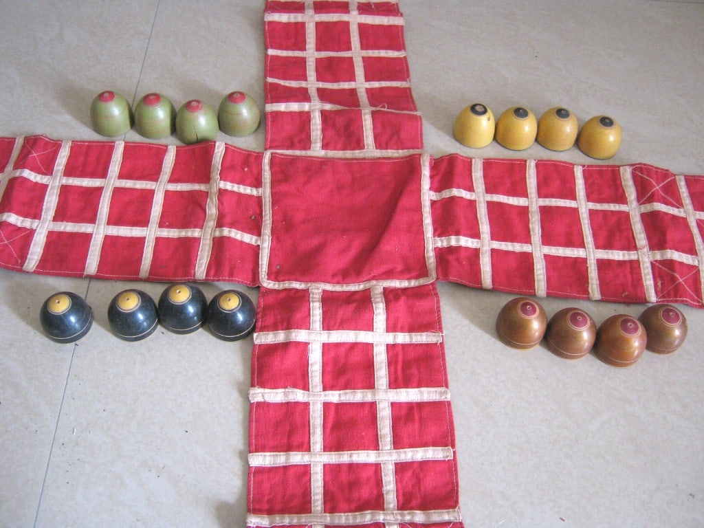 Indian chess ( Chaupar ) , cloth board . wooden pieces: Indian chess ( Chaupar ) , cloth board . wooden pieces . Size of board : 33.00 x 33.00 inch .