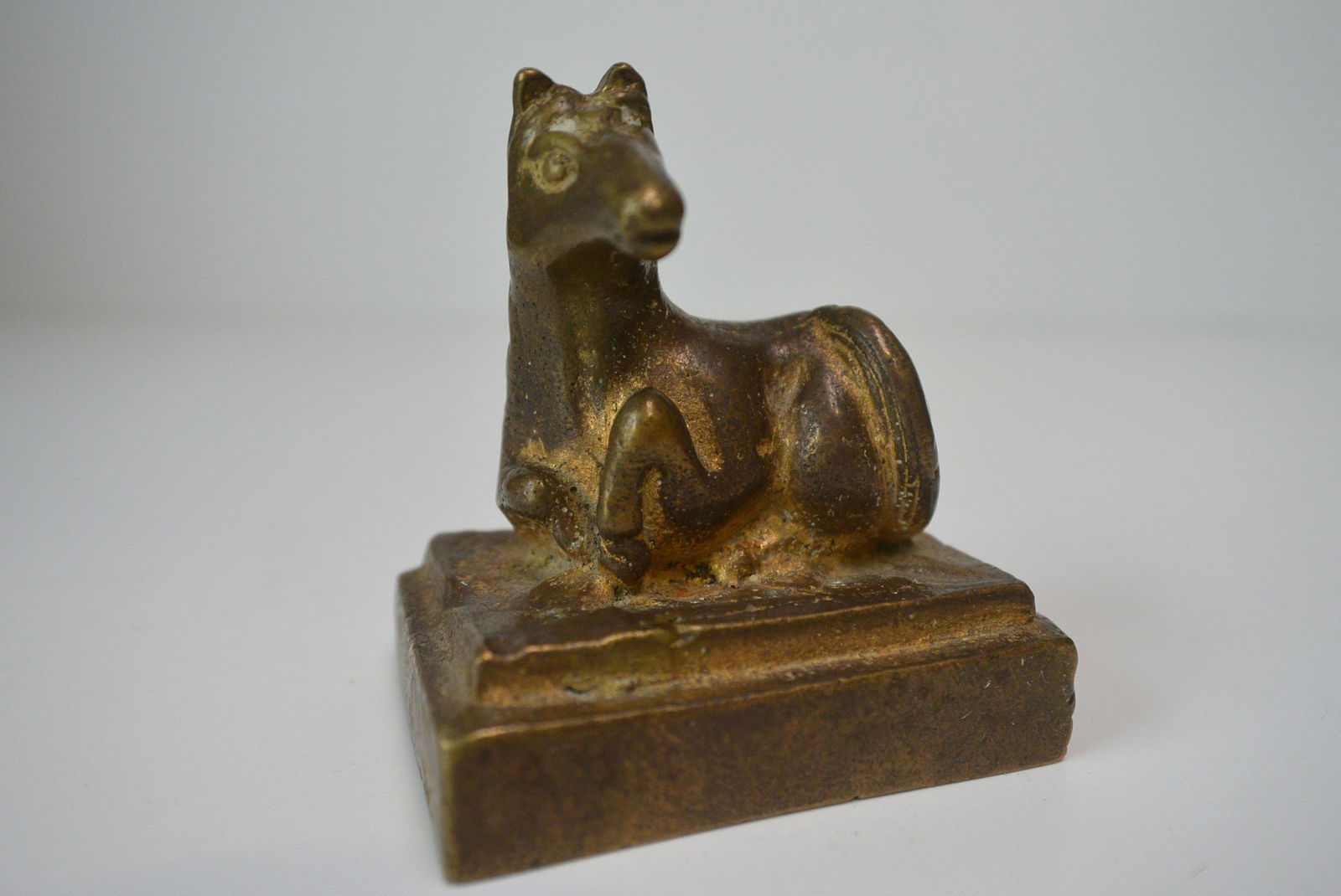 A bronze rectangle seal with a horse sculpture on top, (1 of 7)