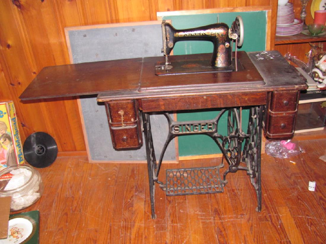 Singer Sewing Machine: Singer Treadle Sewing Machine.Veneer has rippling, some missing pieces of veneer, and fading.