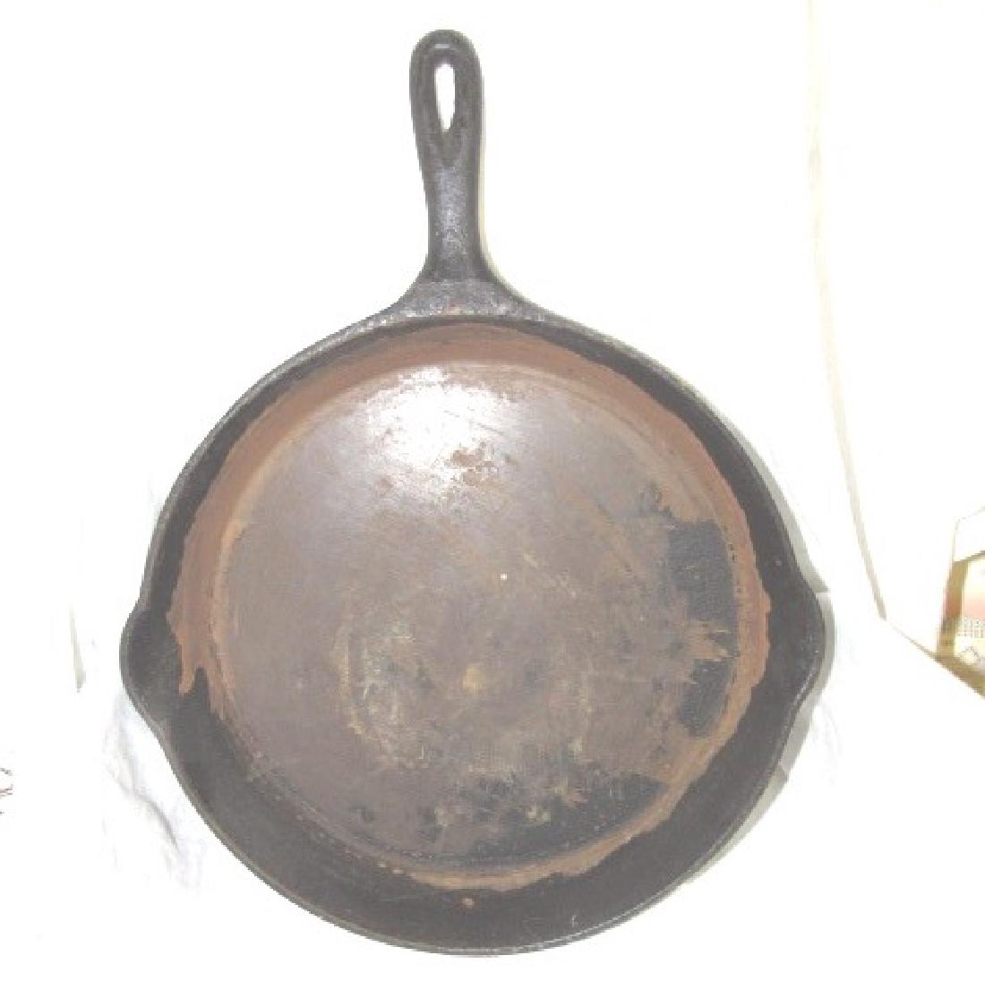 Wagner Ware #12 Cast Iron Skillet #1062: Sits Flat on surface. No visible cracks, but can not see under everything. Sold as is