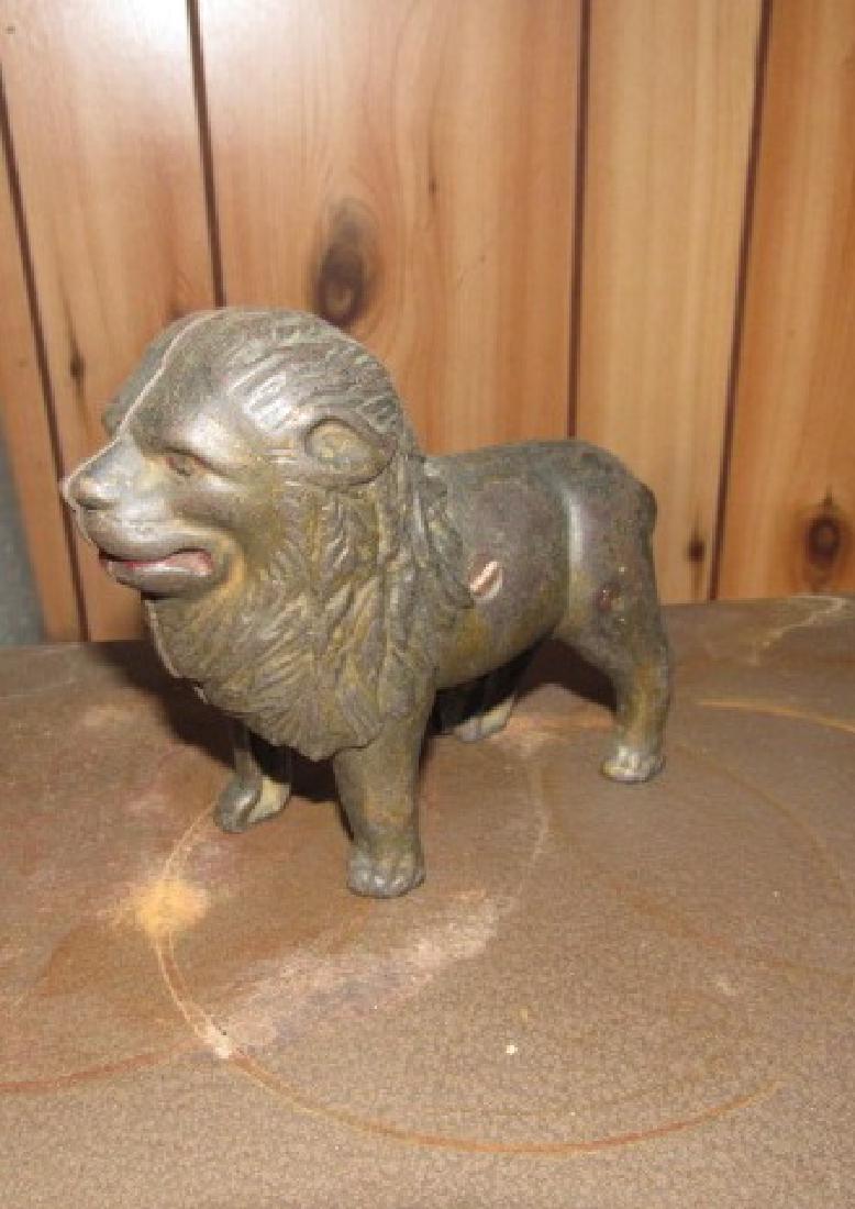 Cast Iron Lion Bank: Approx. 6 3/4" long and 5 1/4" tall.