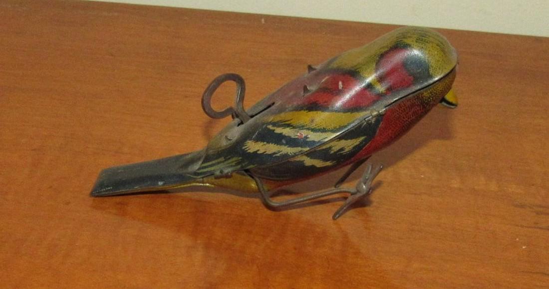 1927 Tin Wind Up Bird Parakeet Toy: Approx. 5 1/4" long. Winds up but will only work slightly is it is on its side