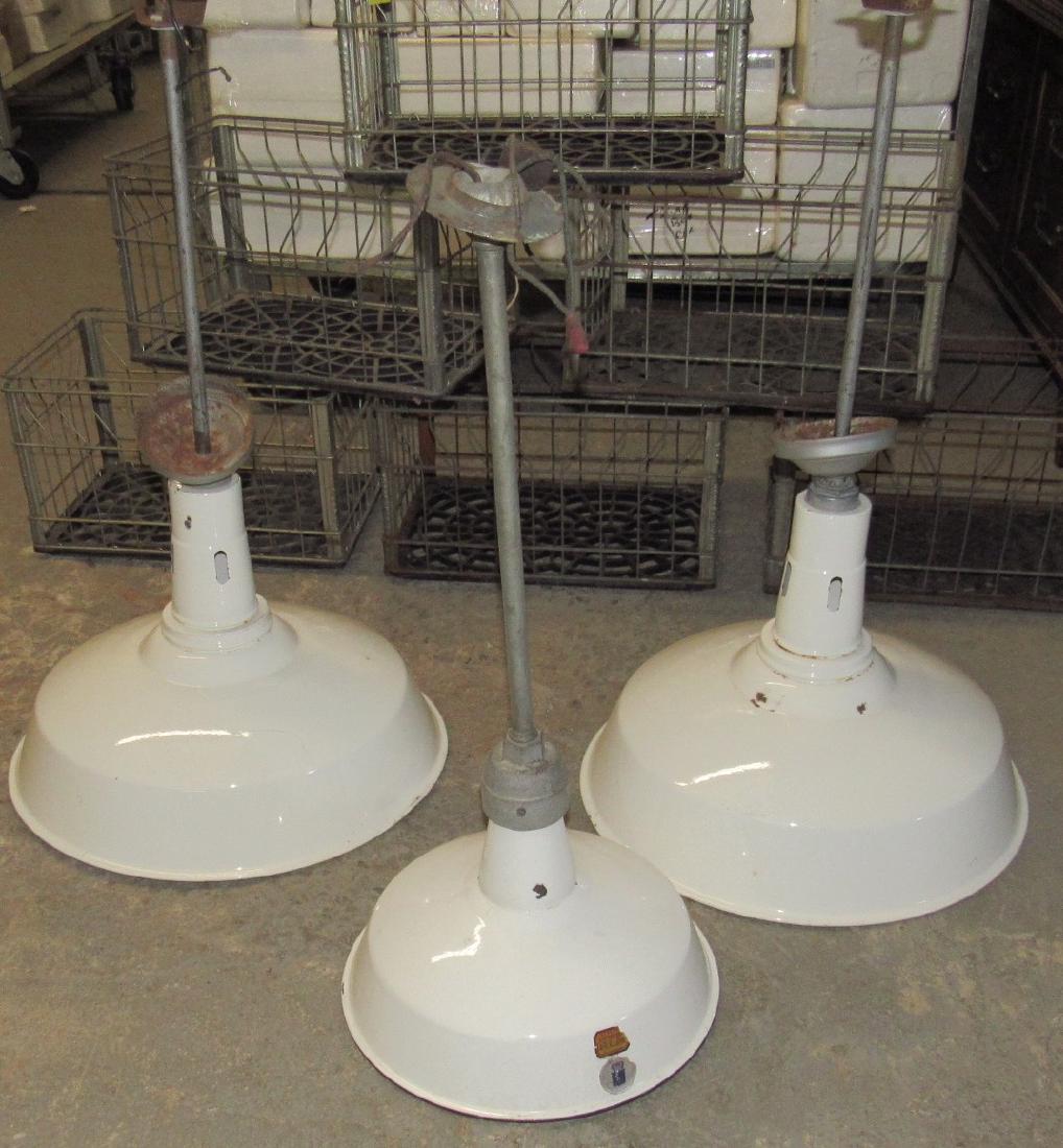 3 White Porcelain Hanging Shades / Fixtures: 2 are approx. 20" in diameter and the other is 14 1/4" in diameter. Very minimal chipping of porcelain. One has small ding on edge.