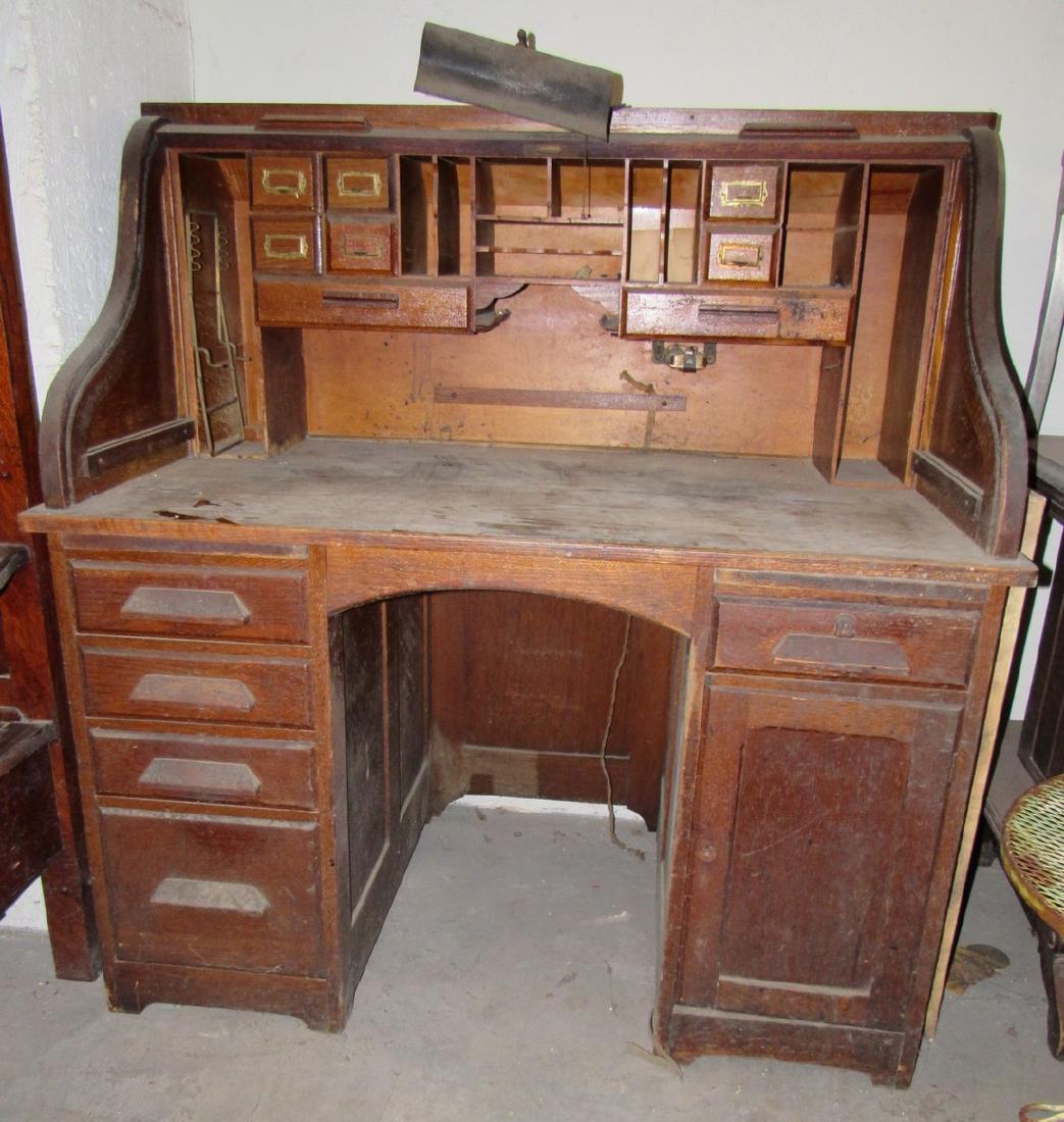Oak Roll Top Desk: Approx. 30" x 48" x 50 1/2" tall . Has light attached to it. Needs cleaning and writing surface redone