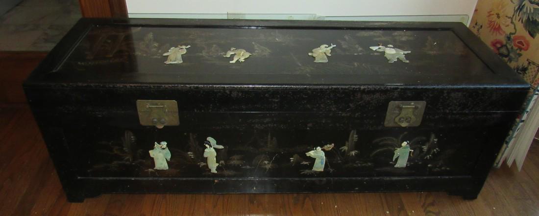 Oriental Chest with Material Contents: Chest is approx 17 1/2" x 53 1/2" x 18" tall. Has some finish loss. Includes contents