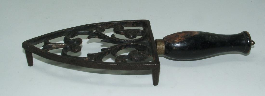 Antique Cast Iron Trivet with Wood Handle: Approx 3 1/2" wide and 9 3/4" long. No chips or cracks