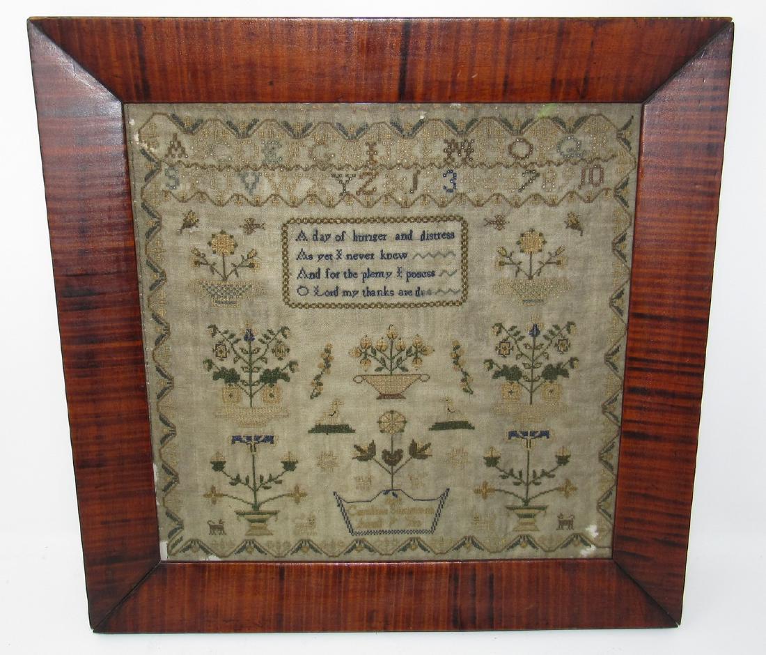 Caroline Simmons 1884 ? Needlework Sampler: Approx 16 1/2" x 16 1/2". Frame has slight damage