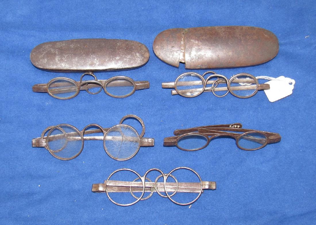 5 Pair of Antique Eyeglasses: One pair is missing the lenses. There is a pair with cracked lens and a pair with chipped lens. Sold as is