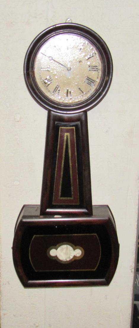 E Howard Banjo Clock: Approx 13 1/2" x 32" .Sold in untested condition. Face has some paint loss.