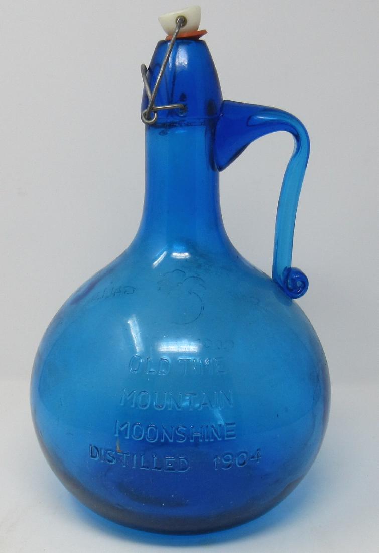 Old Time Mountain Moonshine One Gallon Blue Bottle: Approx 12 1/2" tall . No chips or cracks