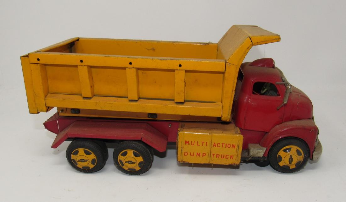 Multi Action Battery Operated Chevy Dump Truck Toy: Approx 13" long. Missing driver side mirror. Needs light cleaning. Sold in untested condition