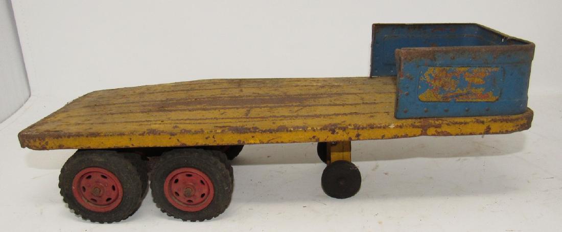 Wyandotte Toys Flat Bed Tractor Trailer: Approx 15 1/2" long. It does have bends to it