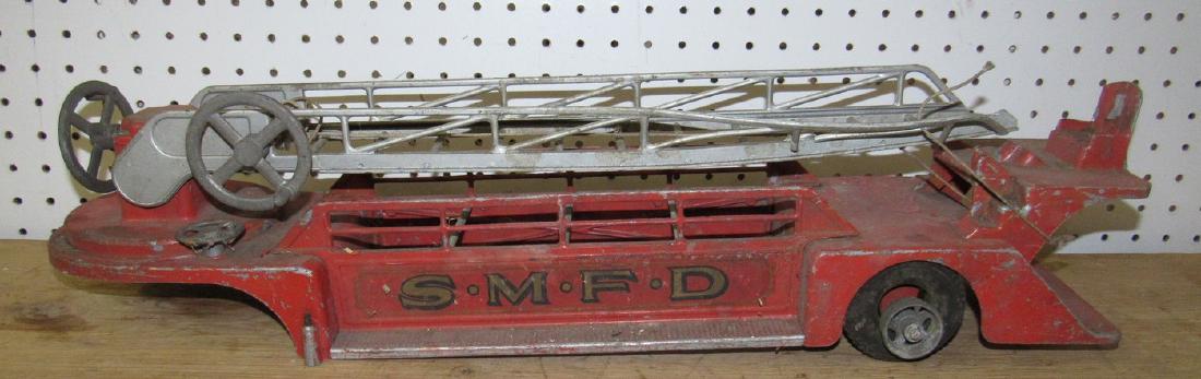 Smith Miller Aerial Fire Truck for Parts or Restore: Approx 26" long. Ladder is broken and it does have damage. Sold as is.