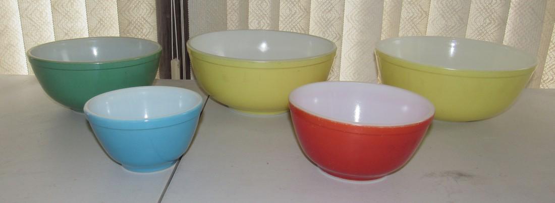 5 Pyrex Mixing Bowls: 2 Largest yellow bowls are approx 10 1/4" in diameter. No chips or cracks to any. All have some sort of light scratches in finish