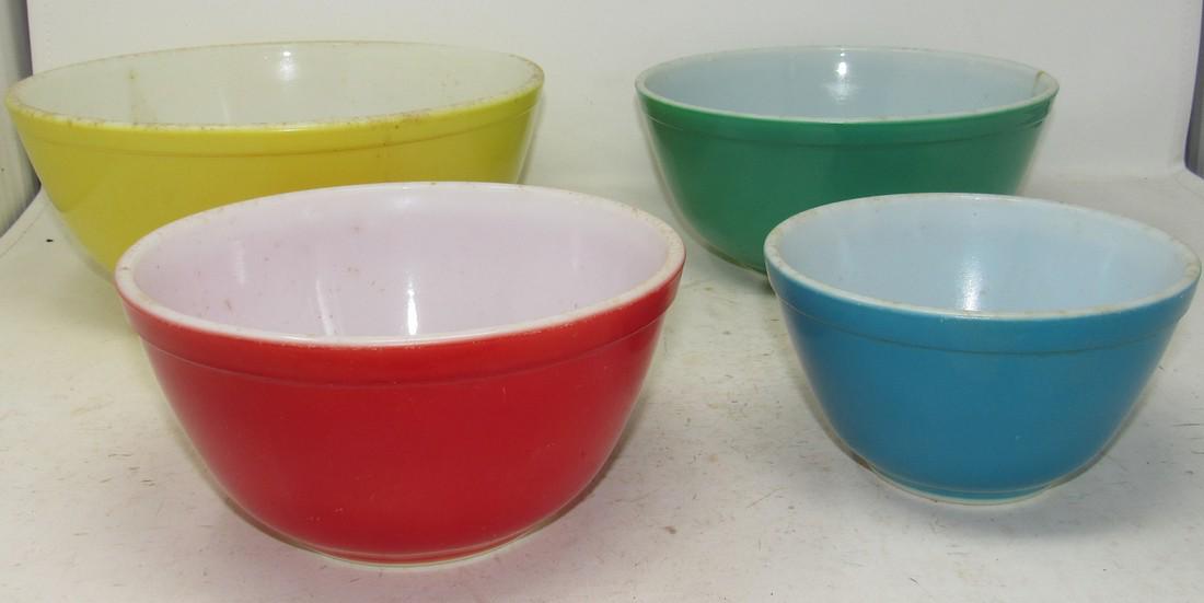 Set of 4 Pyrex Mixing Bowls: Largest is approx 10 1/2" in diameter. All need a good cleaning. Very minimal scratches to finish. No chips or cracks. 1