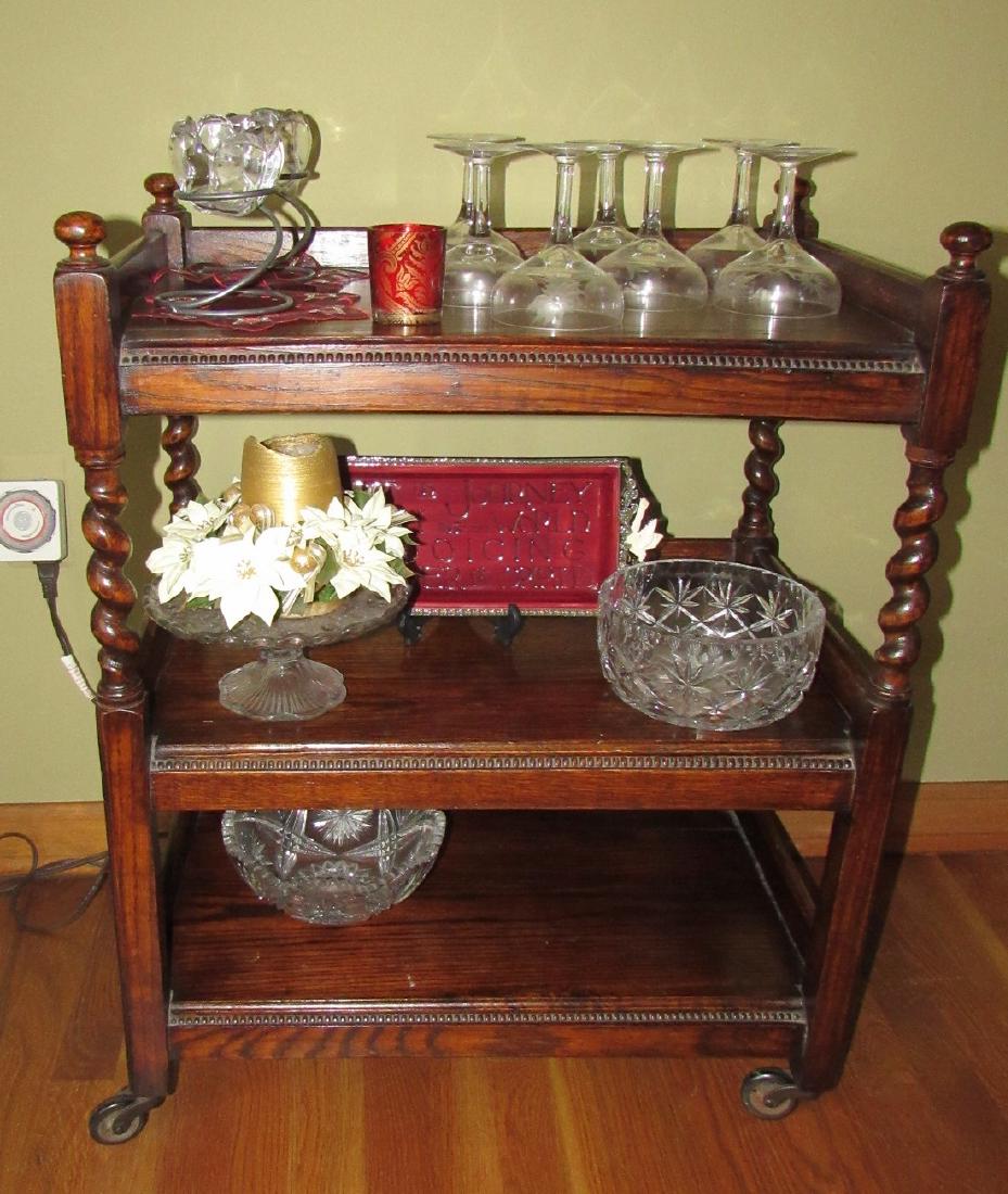 Glassware: Lot includes everything on tea cart. Bowl on very bottom shelf is chipped. Cart sold seperately
